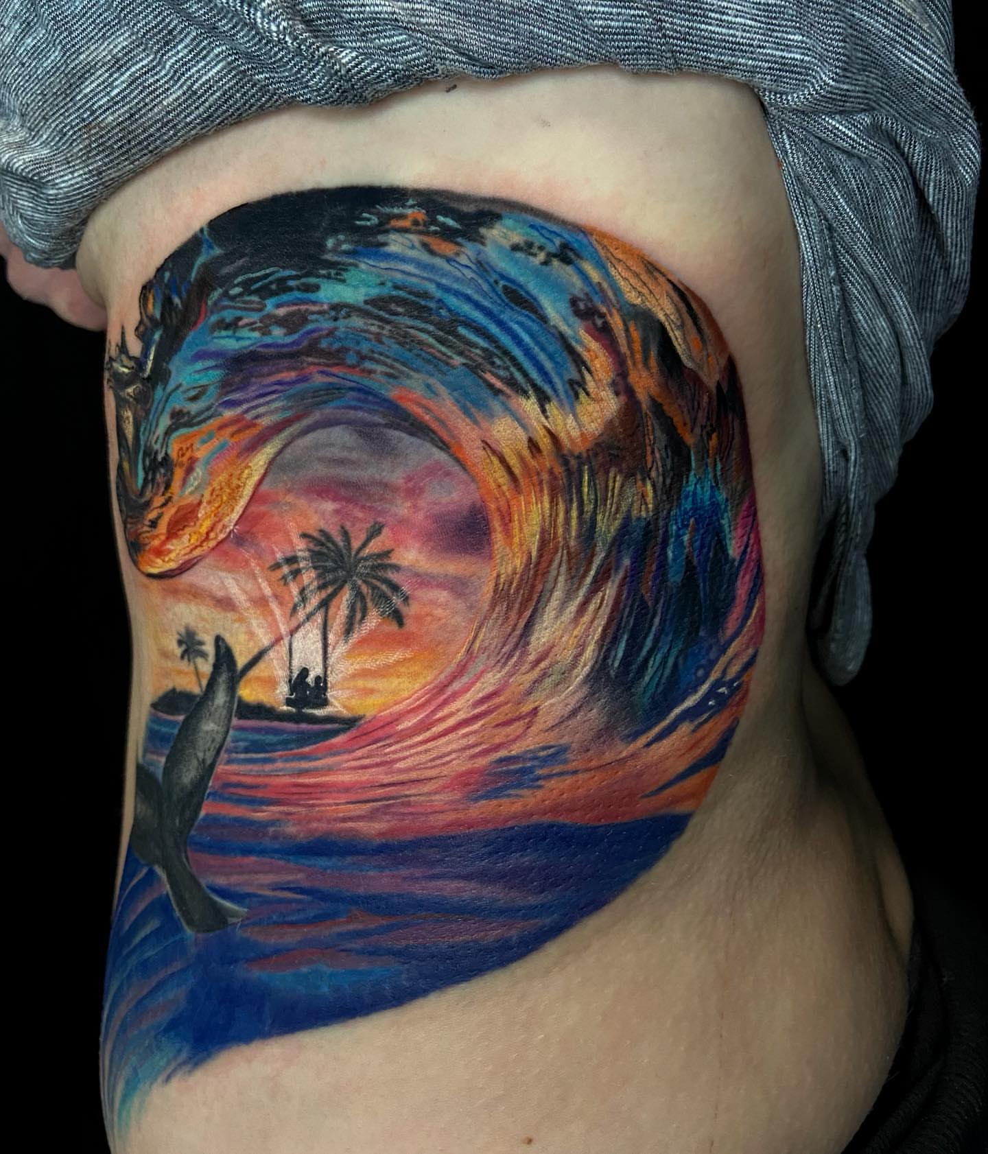 Wave and sunset new school tattoo on the ribs by Jules, Arlington, Texas