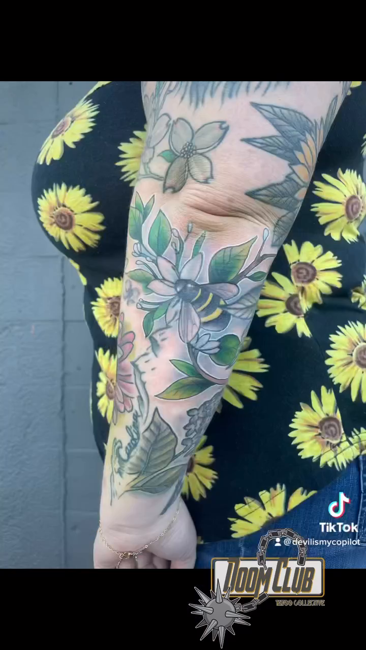 Floral arrangement with a bird neo-traditional tattoo by Nick Harrison, Dayton, Ohio