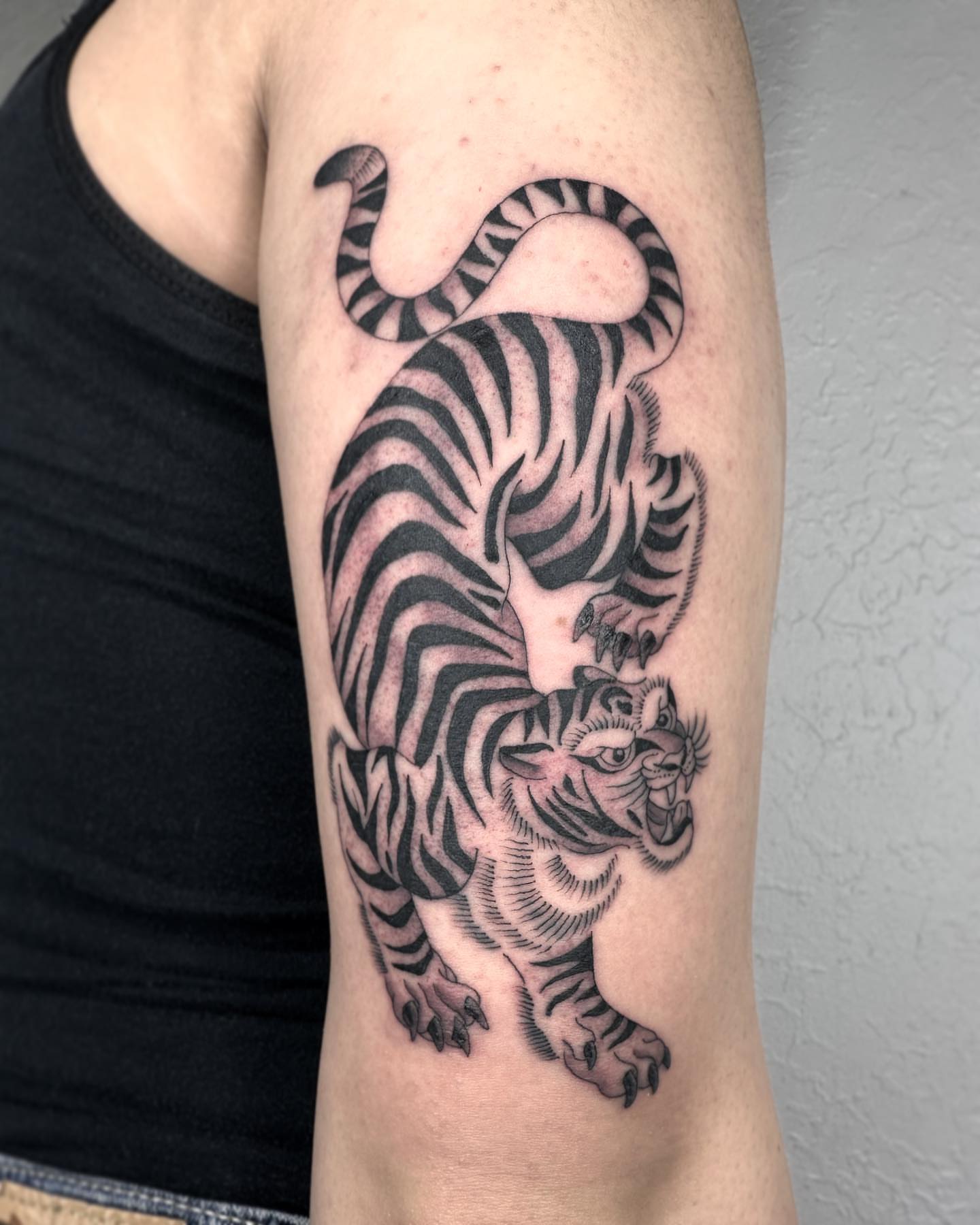 Tiger black and grey tattoo on the forearm by Elijah Edwards