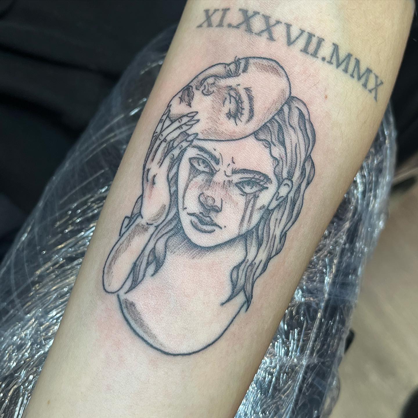 Woman with mask black and grey tattoo on the forearm by Breanna💉🔮, Dover, Delaware