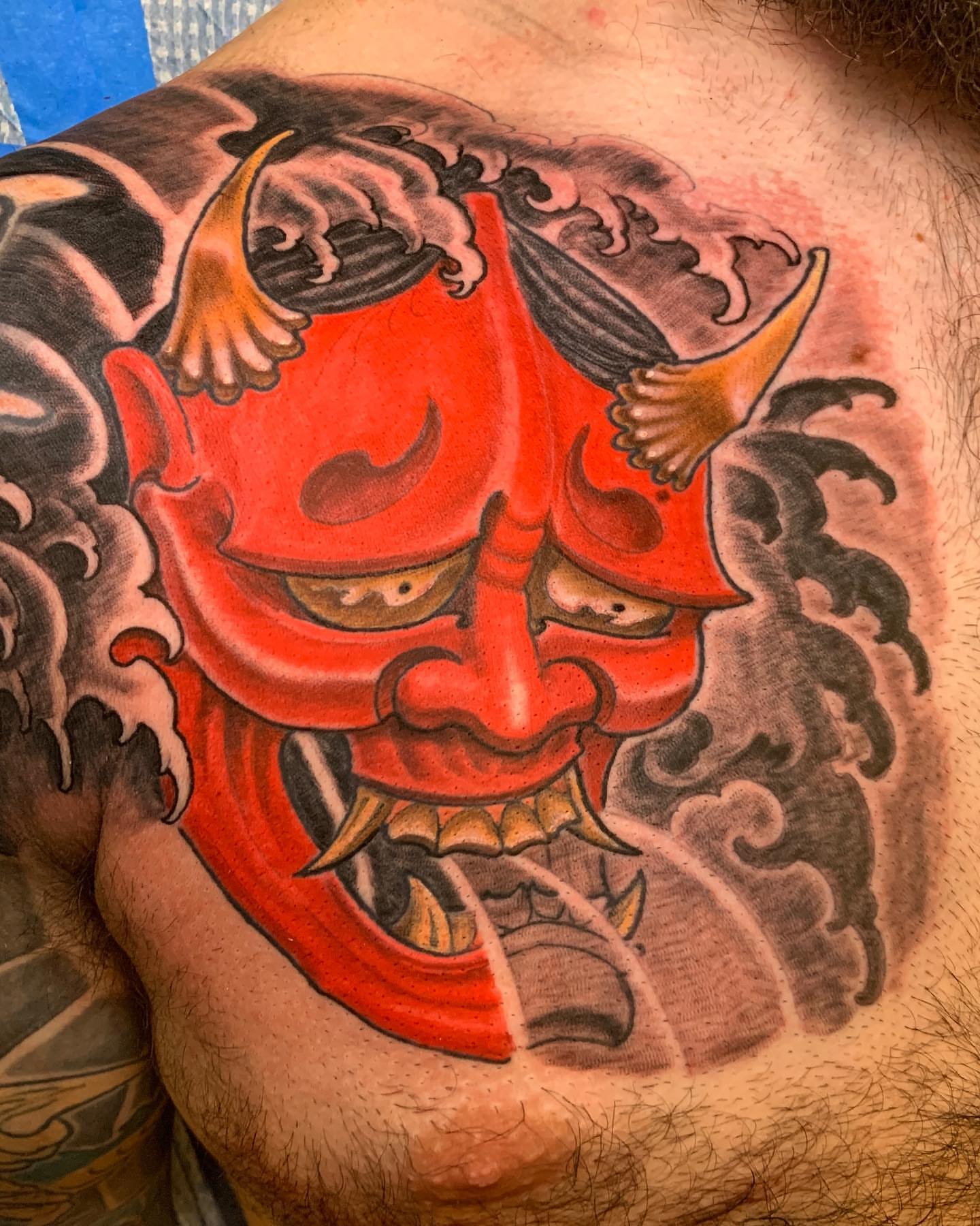 Red demon mask japanese irezumi tattoo on the chest by Jason L.
