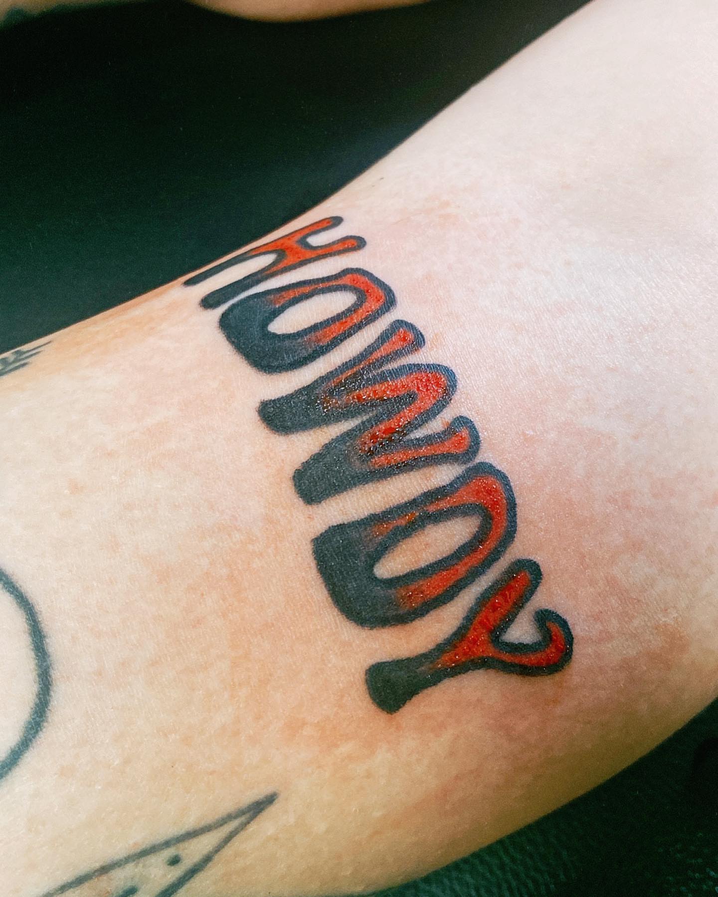 Howdy lettering script tattoo on the forearm by Myka King