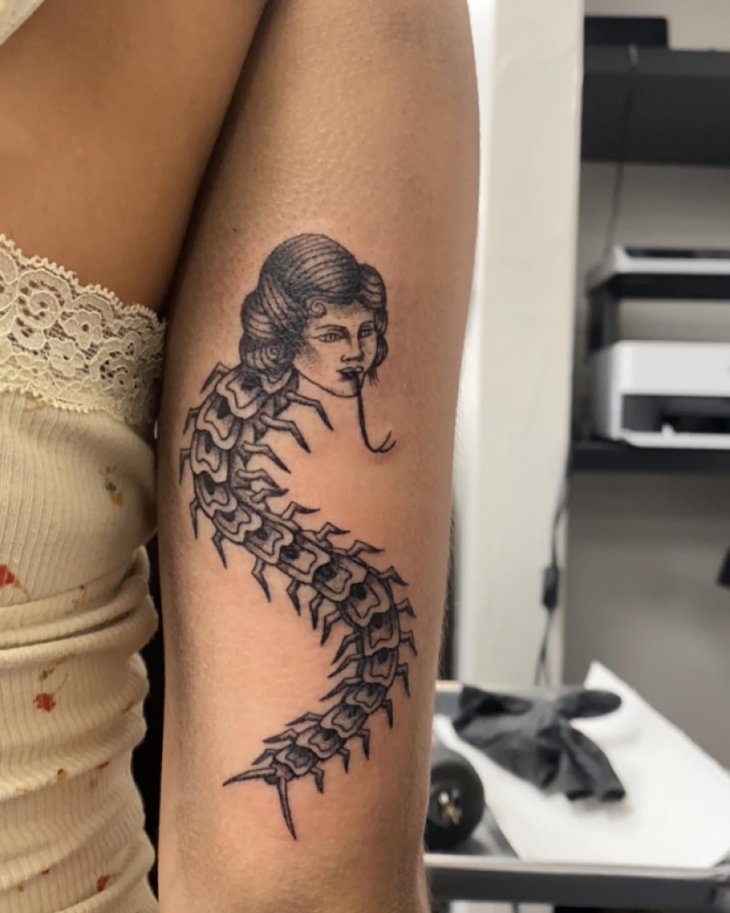 Centipede woman black and grey tattoo on the forearm by Kenzie🖤