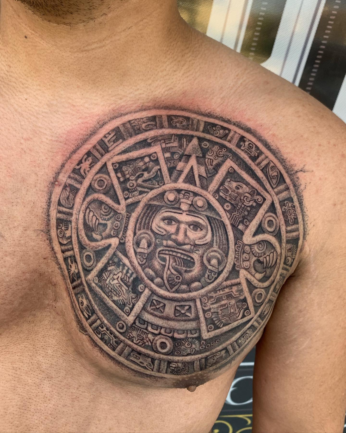 Mayan calendar black and grey tattoo on the chest by Luis VP