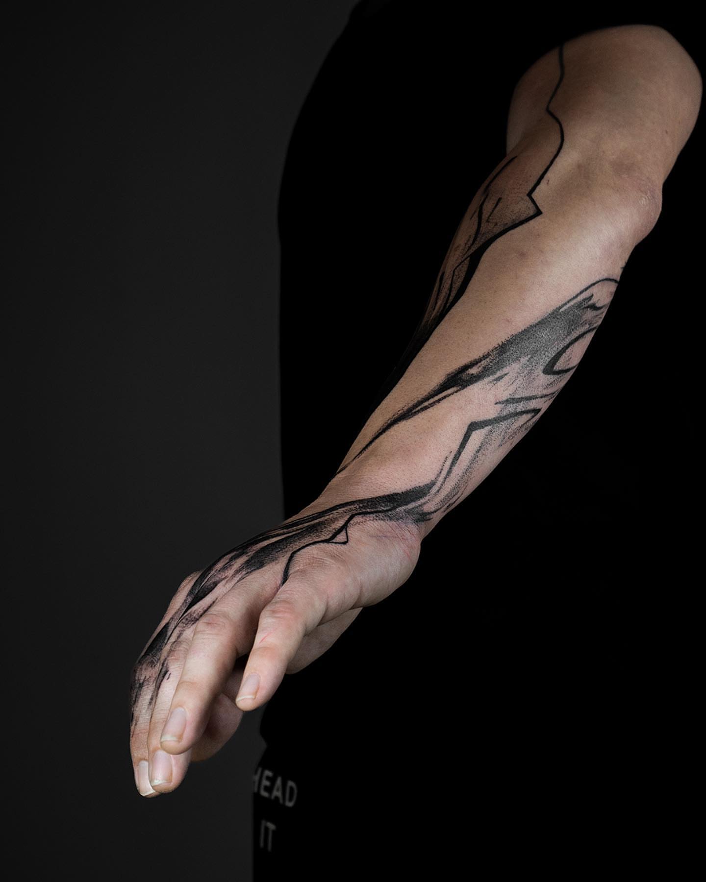 Abstract lines black and grey tattoo on the forearm by Pietro Moleti