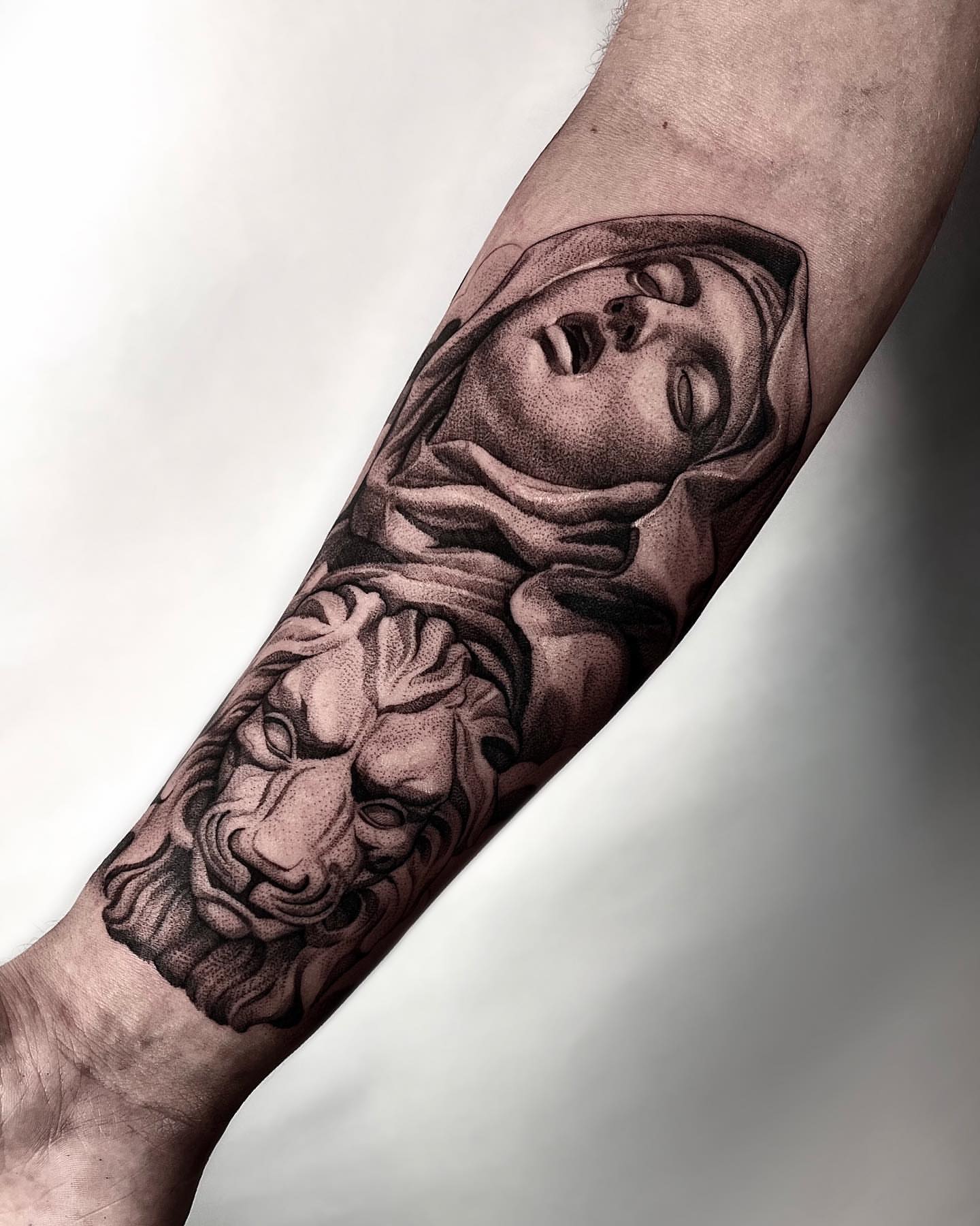 Woman's head with lion realism tattoo on the forearm by Enrique Martinez