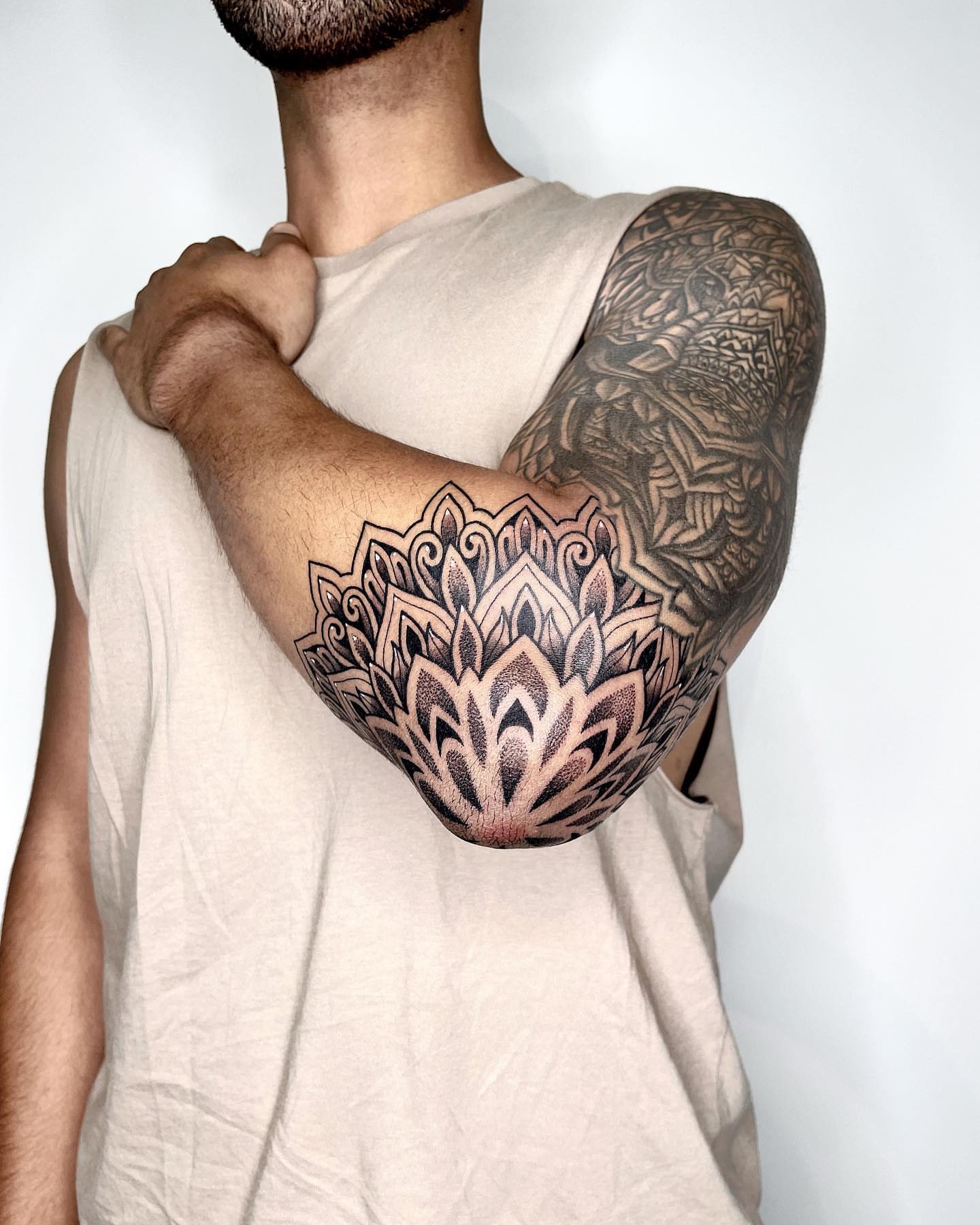 Lotus flower dotwork tattoo on the upper arm by LA tattoo