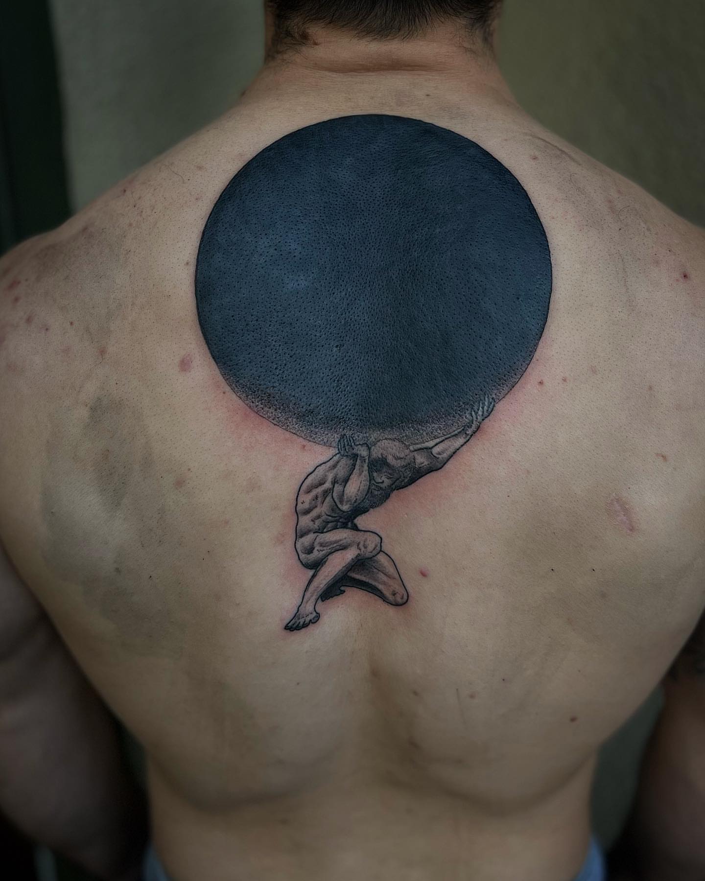 Atlas carrying globe black and grey tattoo on the back by Daniel Patrick