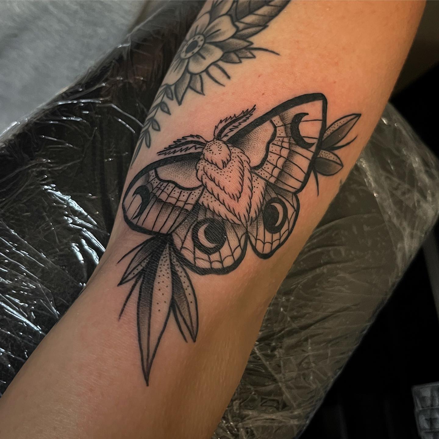 Moth black and grey tattoo on the forearm by Christopher McGlone