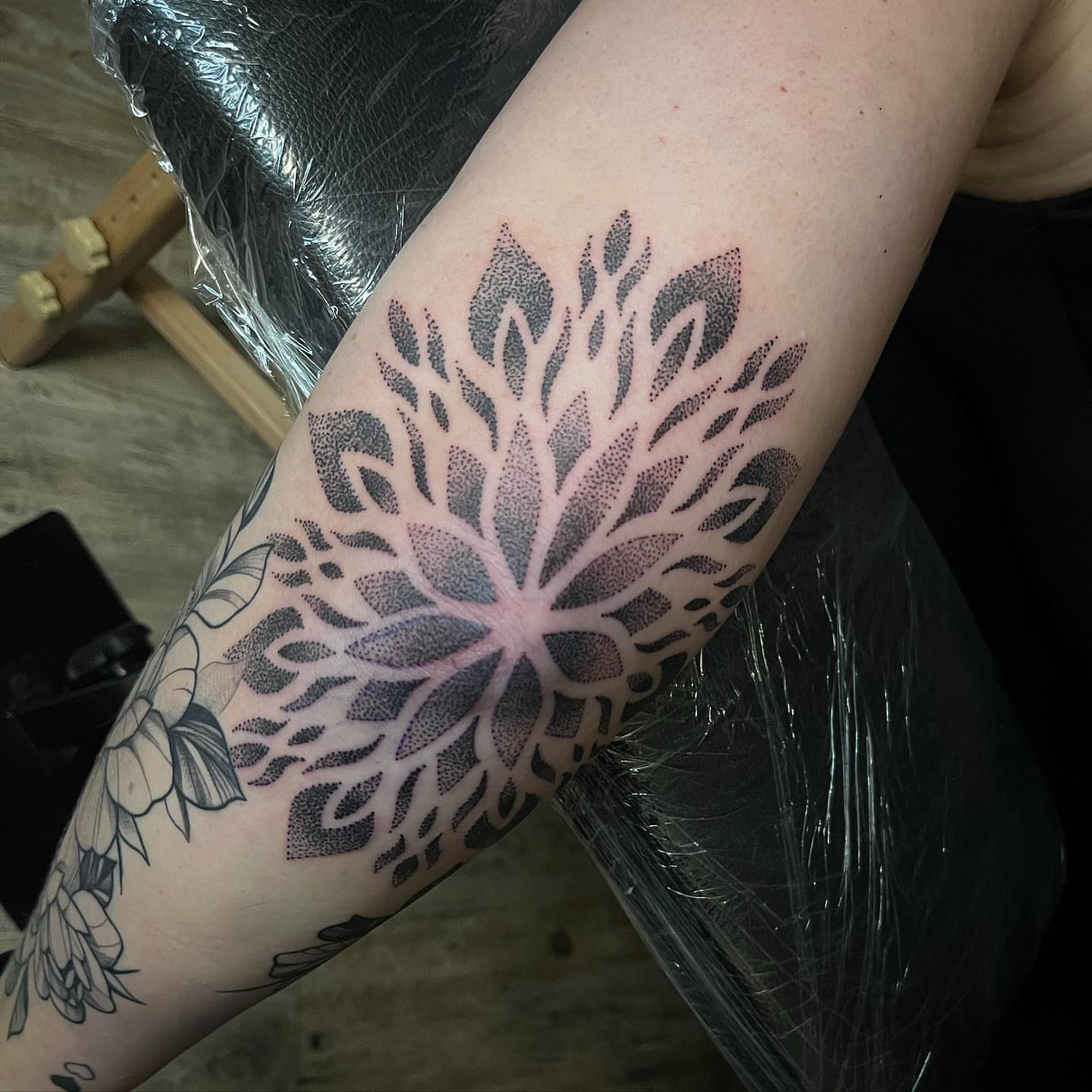 Lotus flower dotwork tattoo on the forearm by Christopher McGlone