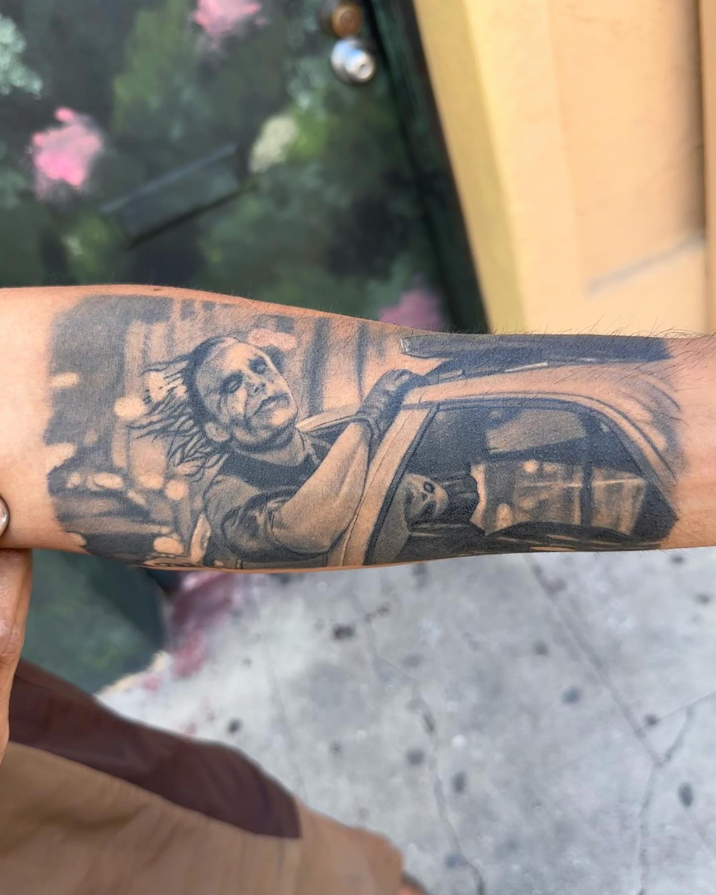 Man driving car realism tattoo on the forearm by Junior Nunez