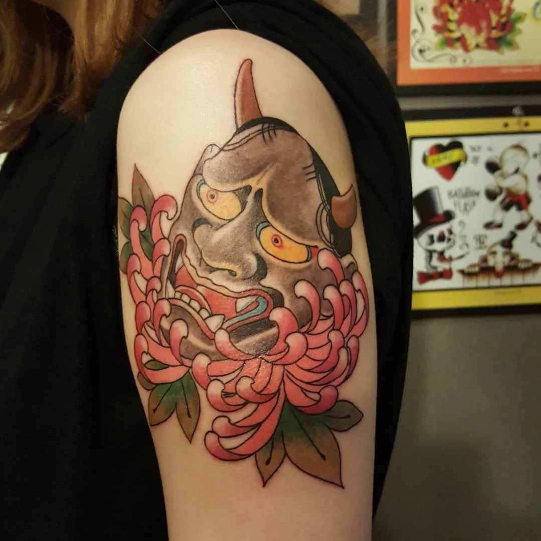 Mask with chrysanthemum American traditional tattoo on the shoulder by zamix_traditional, San Francisco, California