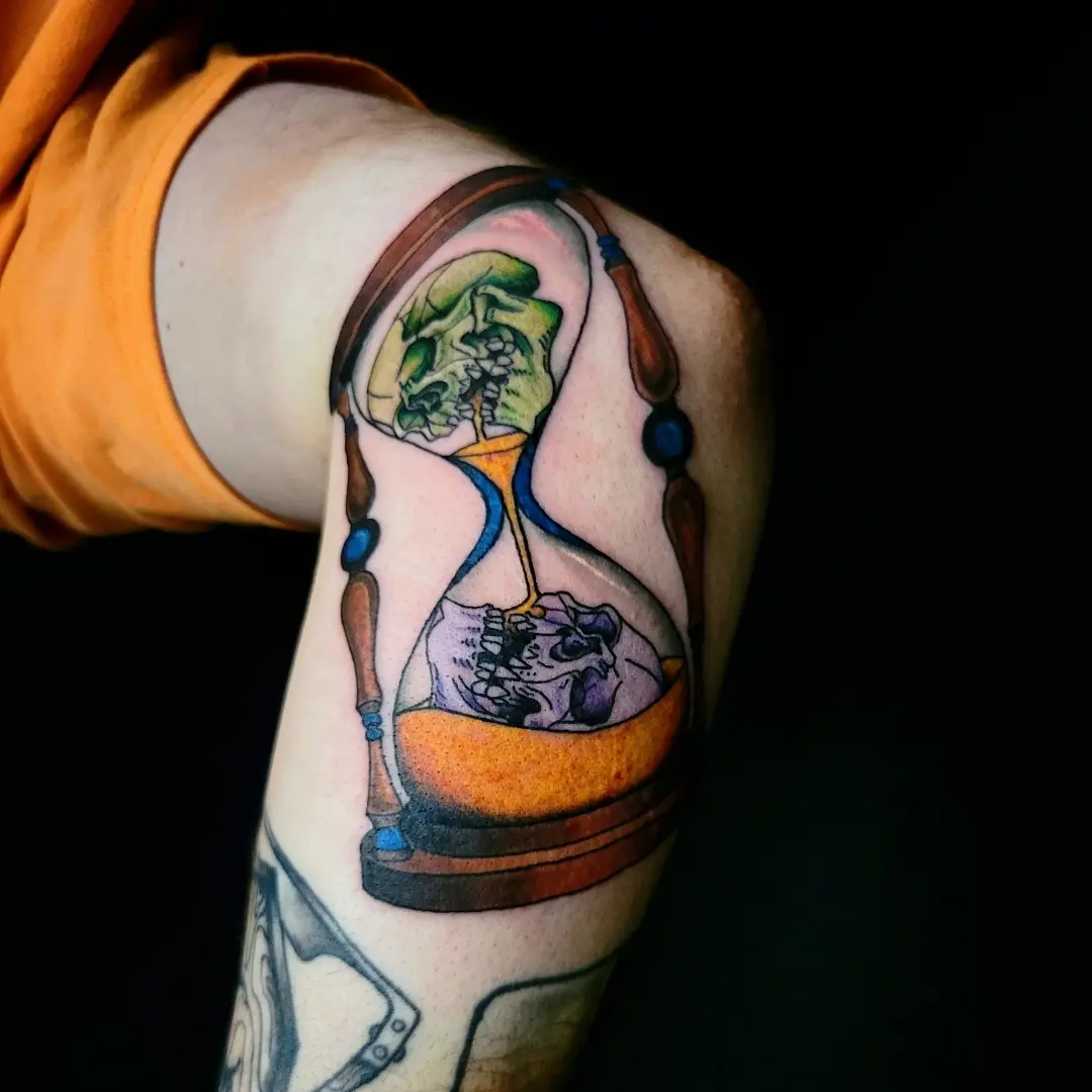 Hourglass with skulls dotwork tattoo on the forearm by Nicole Bett