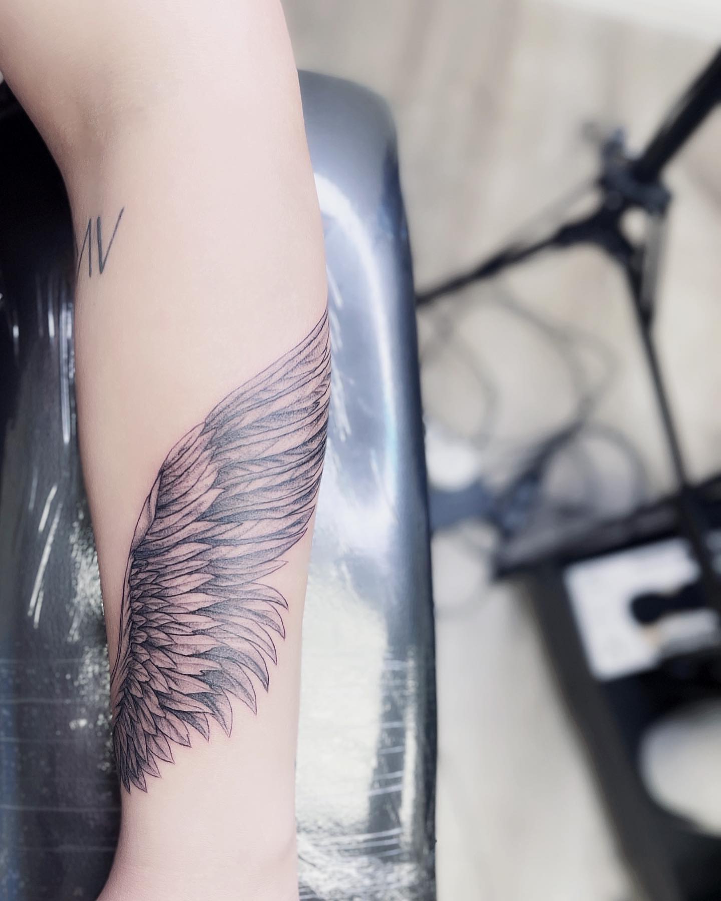 Wing black and grey tattoo on the forearm by New Root Ink _Studio