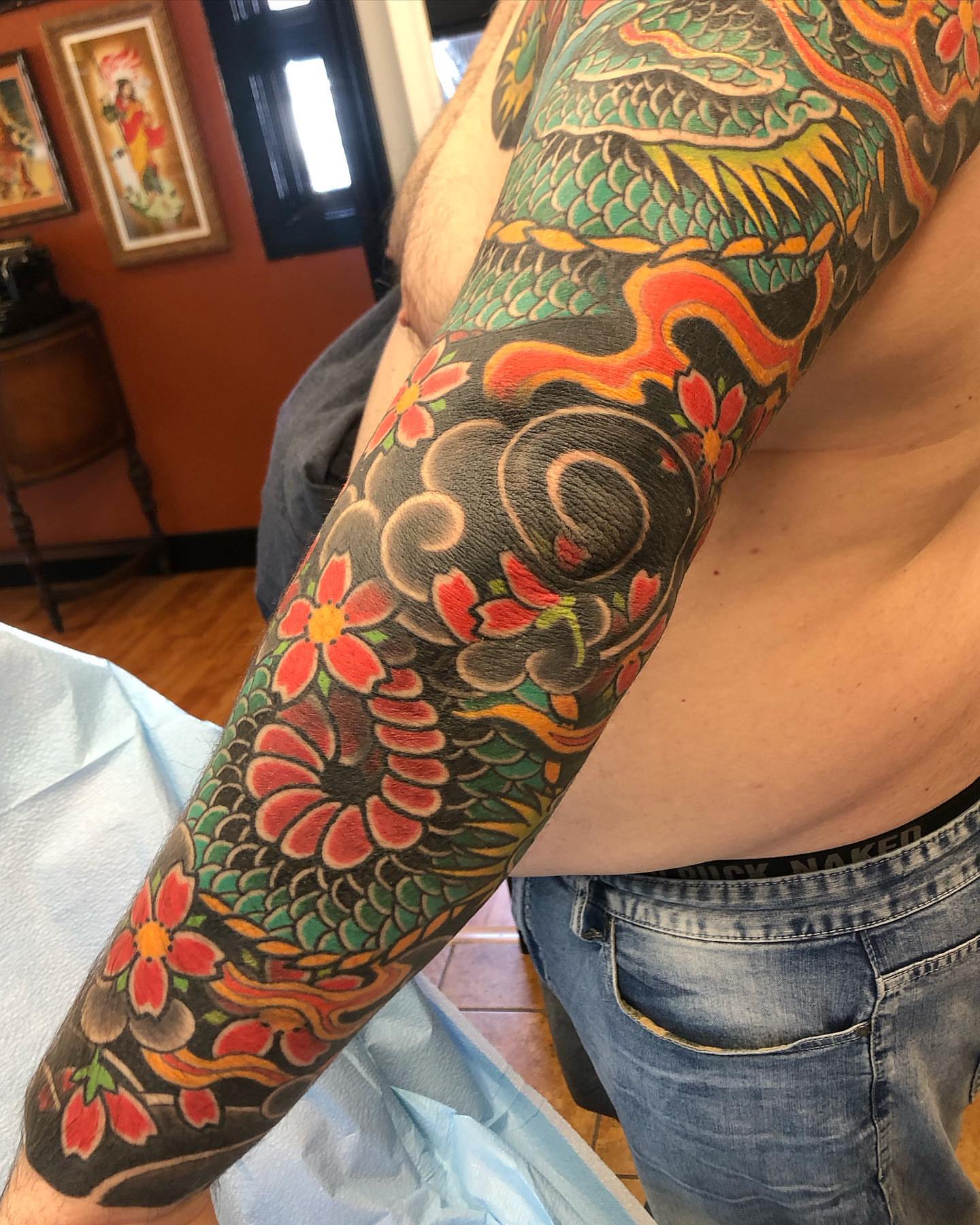 Floral and dragon japanese irezumi tattoo on the upper arm by Steven Campbell, Kansas City, Missouri