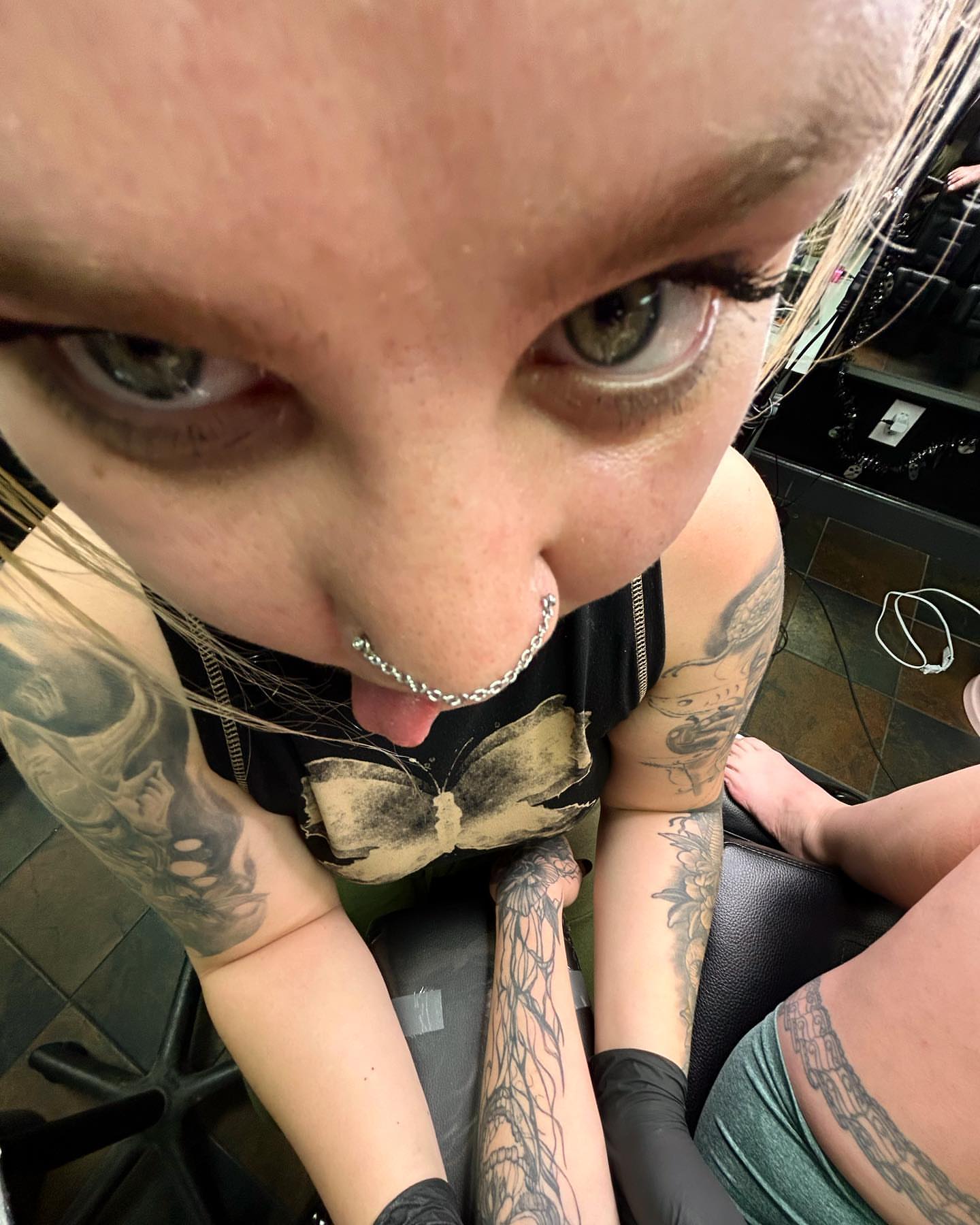 Bow tie black and grey tattoo on the upper arm by Haley