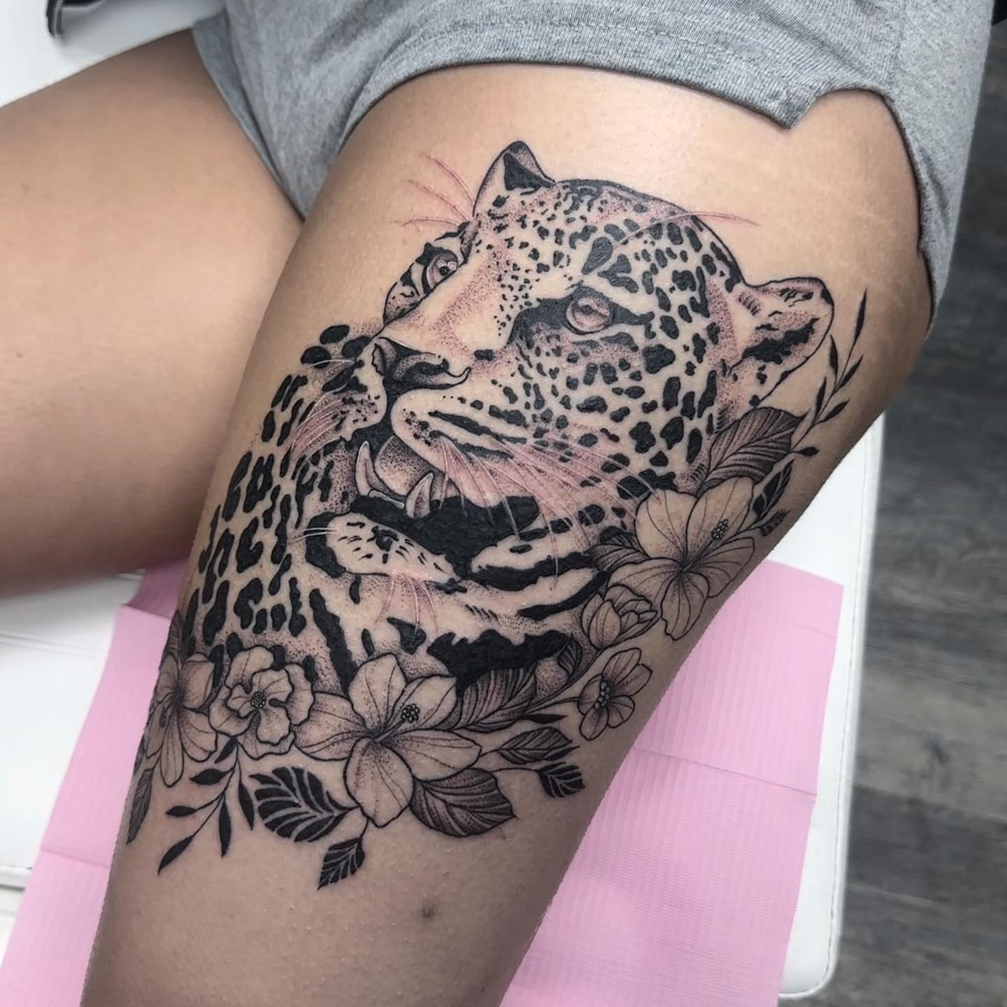 Jaguar with flowers dotwork tattoo on the thigh by ๐๐๐๐ ๐๐๐๐