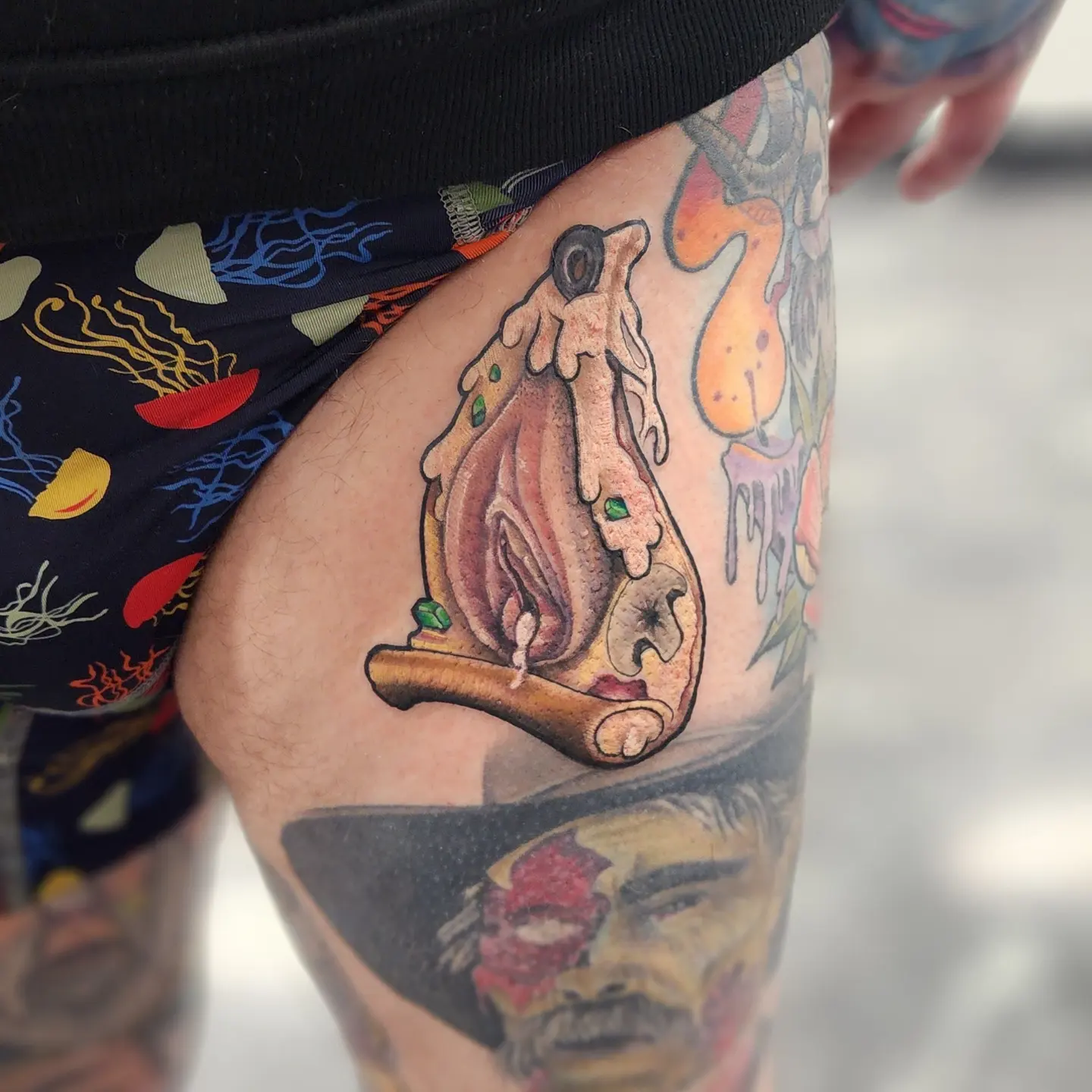 Mechanical creature tattoo on the thigh by Jon Goad