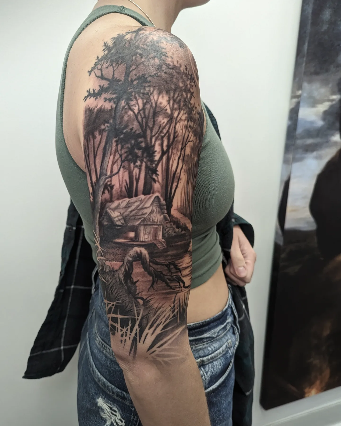 Forest landscape realism tattoo on the upper arm by Sean Costello