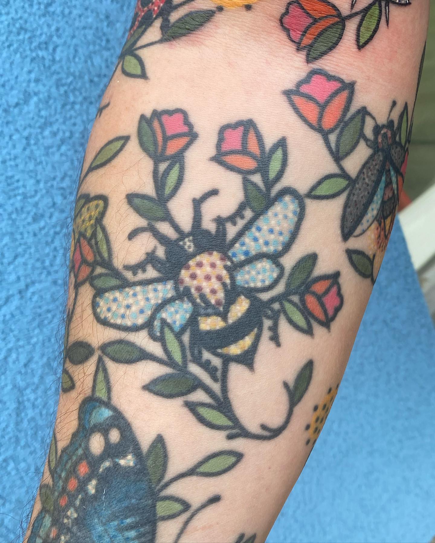 Bees and flowers American traditional tattoo on the forearm by Rat Girl, Dayton, Ohio