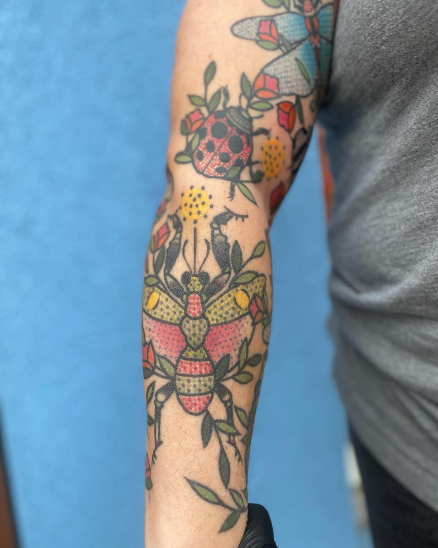 Insect and floral American traditional tattoo on the forearm by Rat Girl, Dayton, Ohio