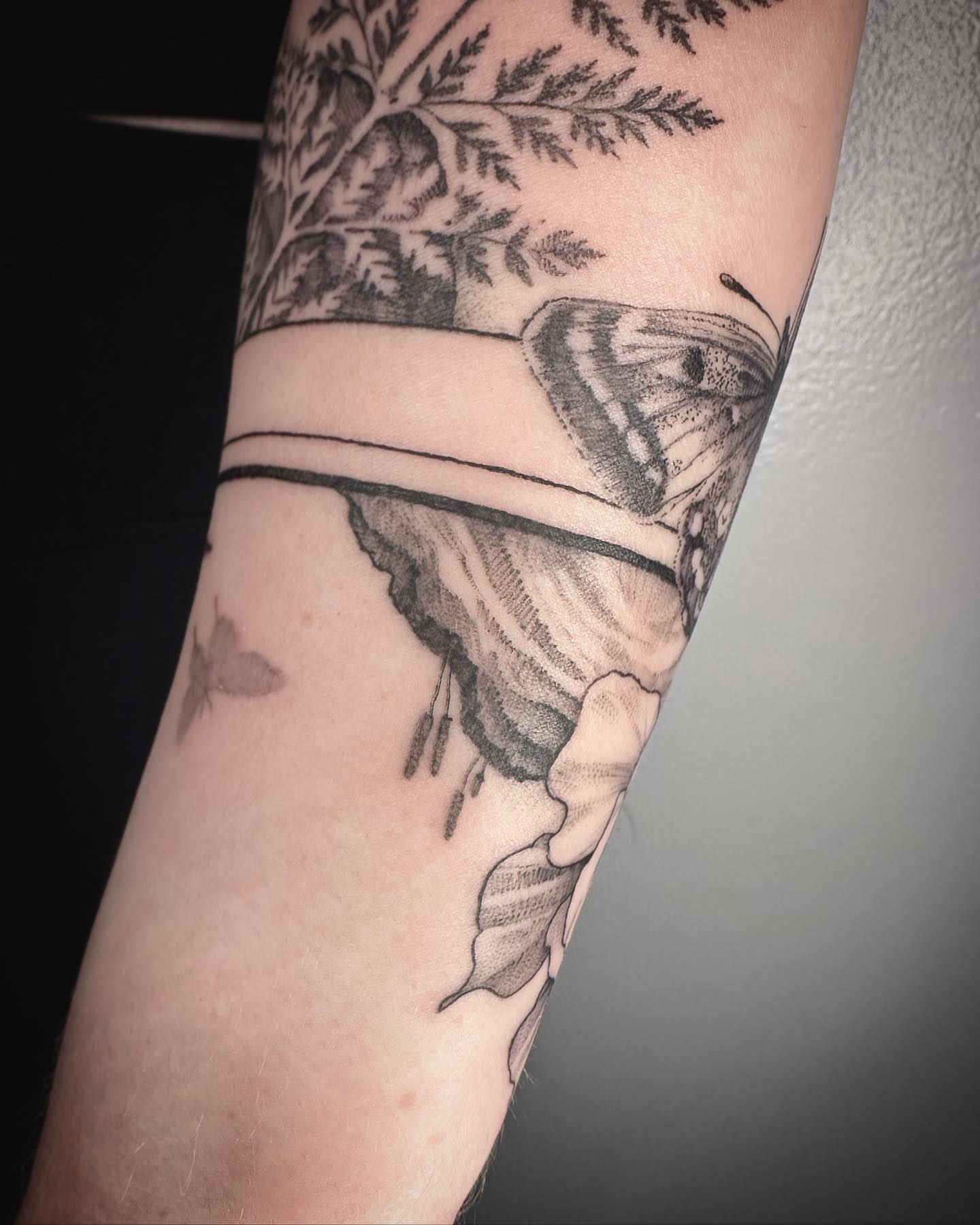 Butterfly and foliage realism tattoo on the forearm by Stephanie Shortsleeve