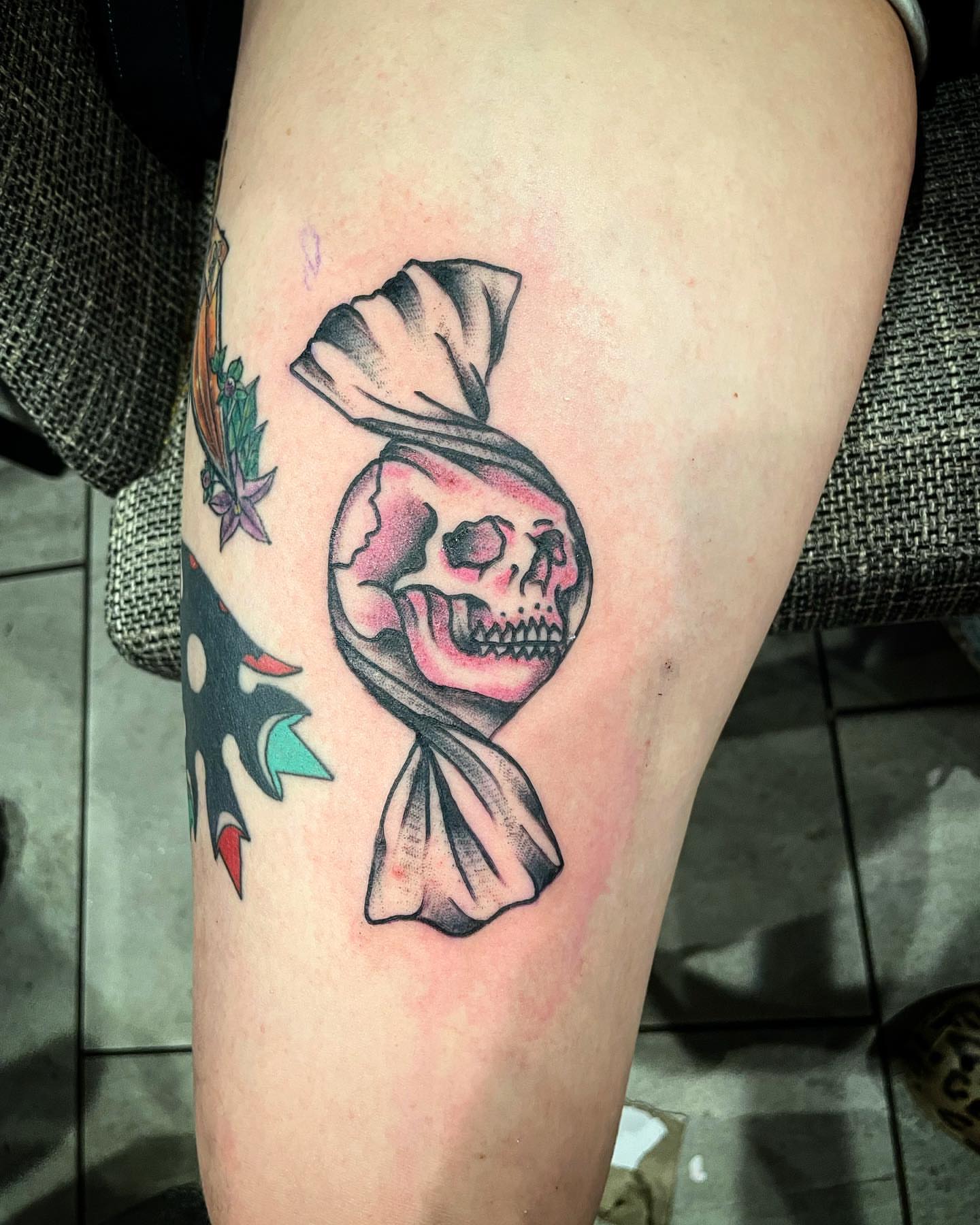 Skull wearing hat American traditional tattoo on the thigh by Kimberly Shordon