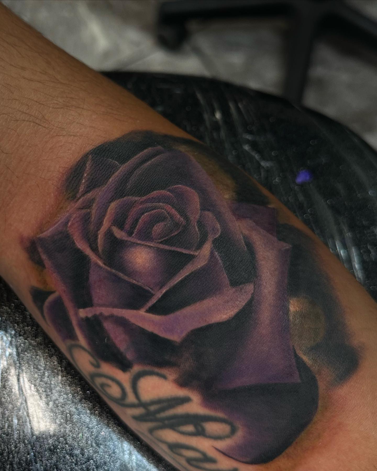 Purple rose dark realism tattoo on the forearm by Billy Harris