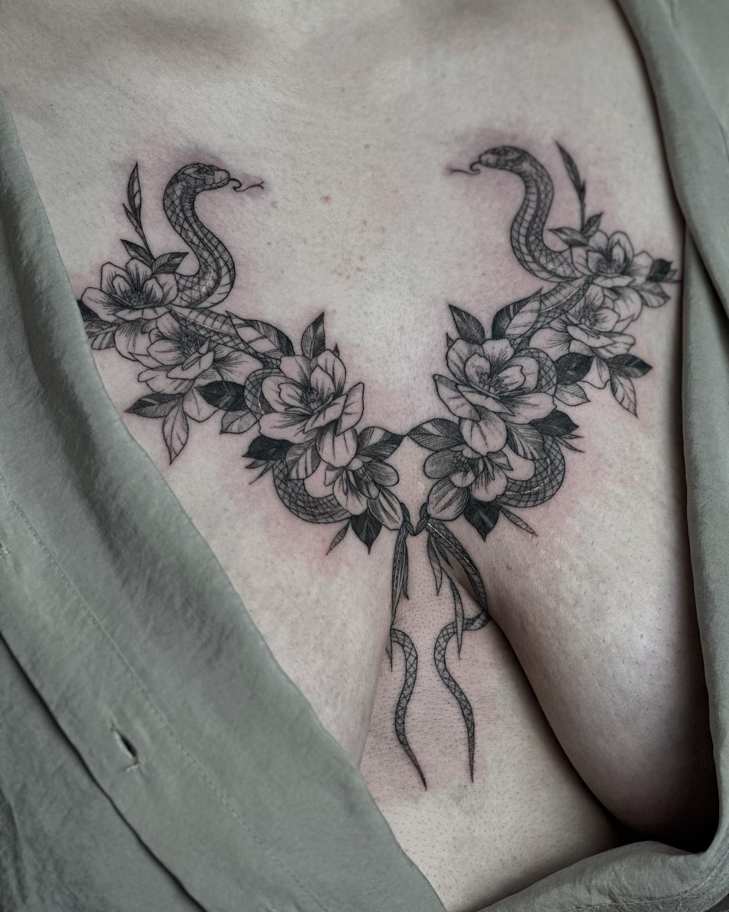 Snake and flowers black and grey tattoo on the chest by Liv