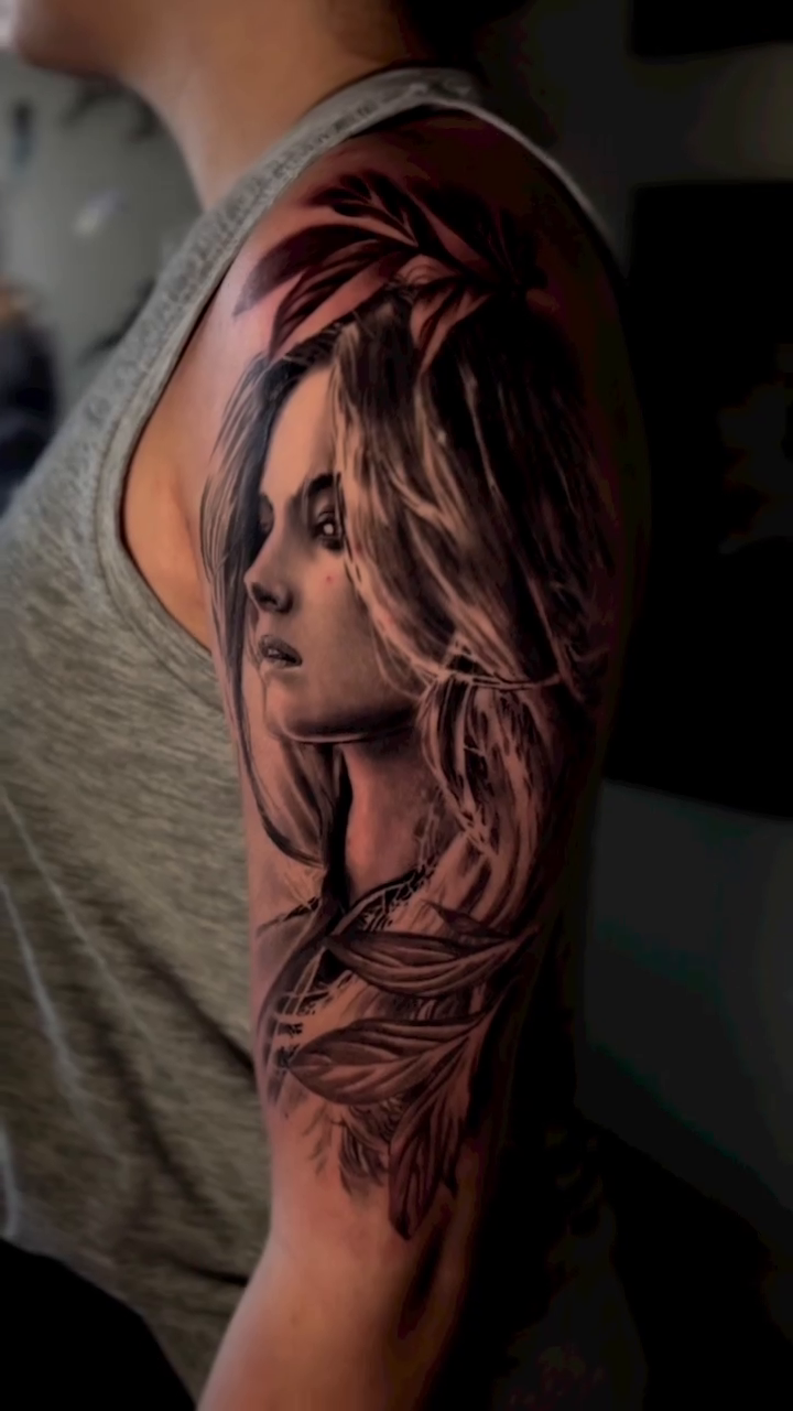 Woman's portrait with feathers realism tattoo by Ryan Gage Gonzalez