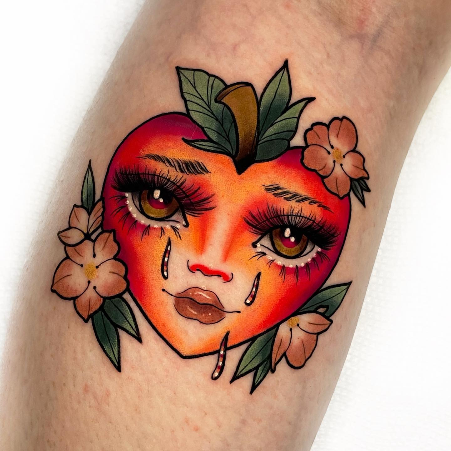 Apple with face American traditional tattoo on the forearm by 𝐊𝐚𝐫𝐚 𝐍𝐨𝐞𝐥, Dallas, Texas