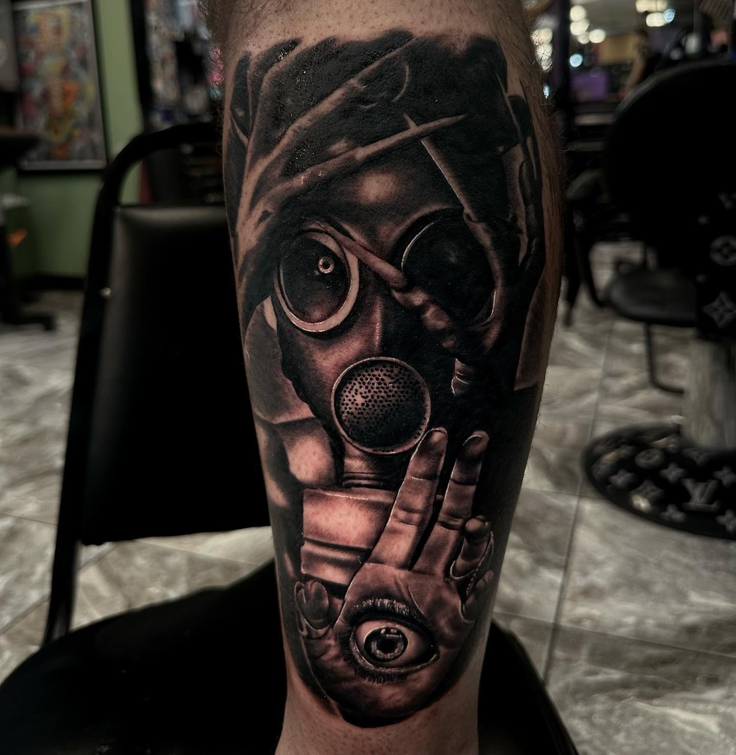 Gas mask and hand realism tattoo on the forearm by Billy Harris