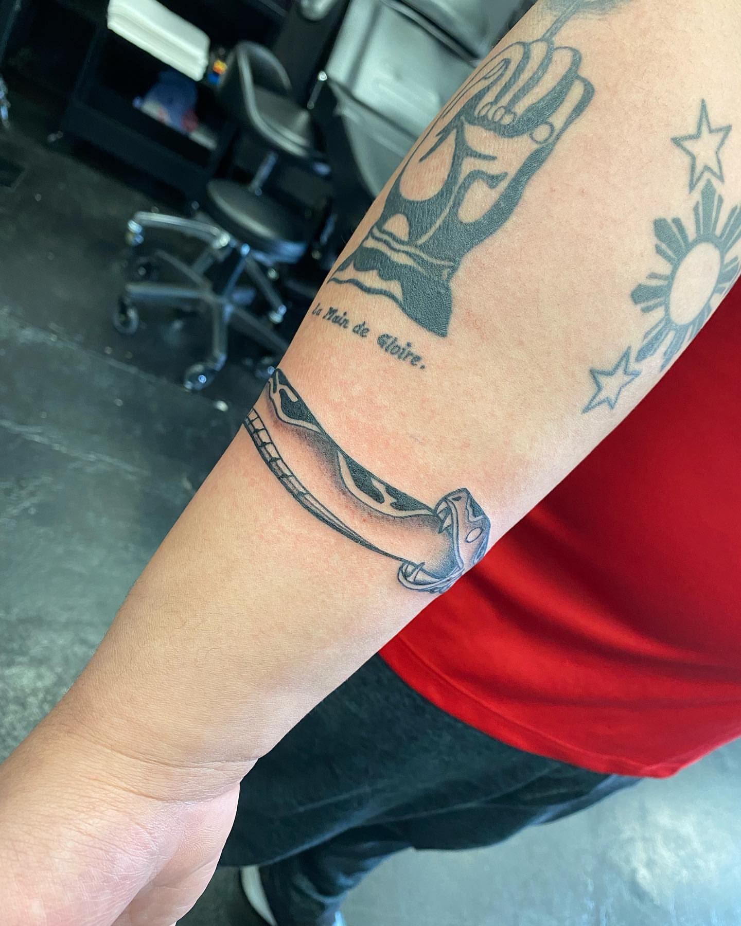 Hand and stars black and grey tattoo on the forearm by S C O T T