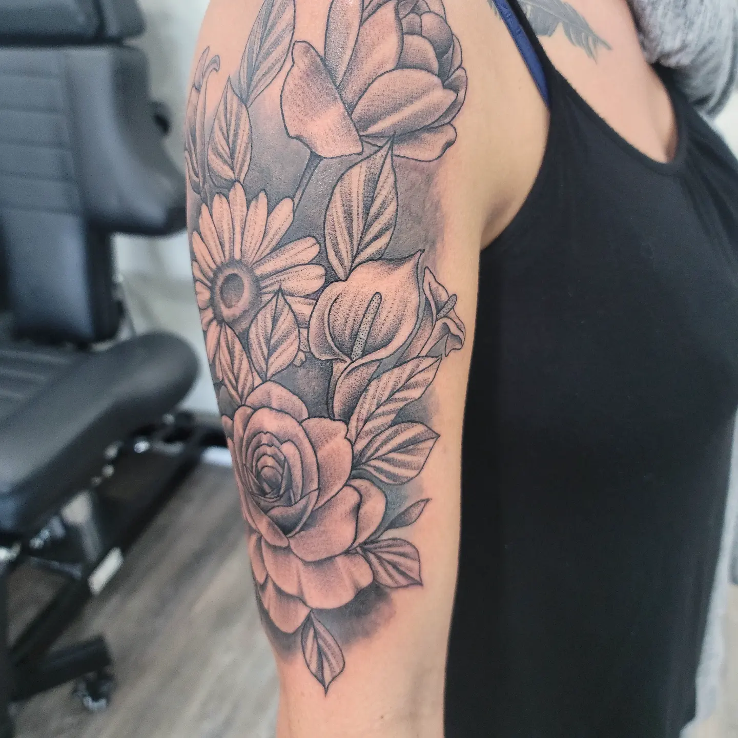 Floral bouquet realism tattoo on the forearm by Dick Eckman