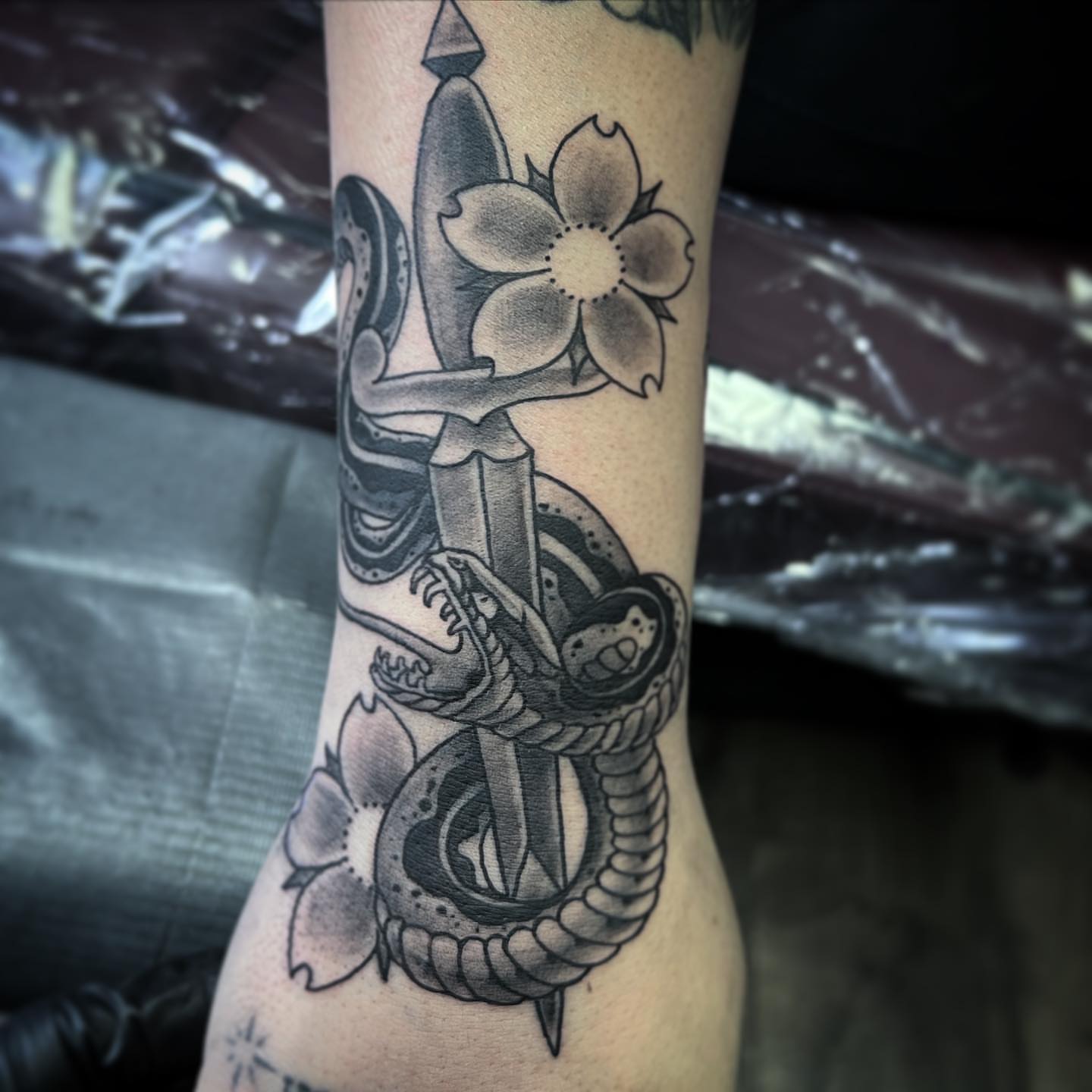 Sword and snake American traditional tattoo on the forearm by TyEsha Reels
