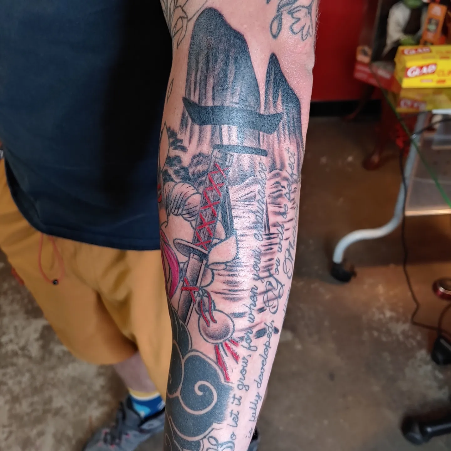 Astronaut and rocket American traditional tattoo on the forearm by Gene Britton