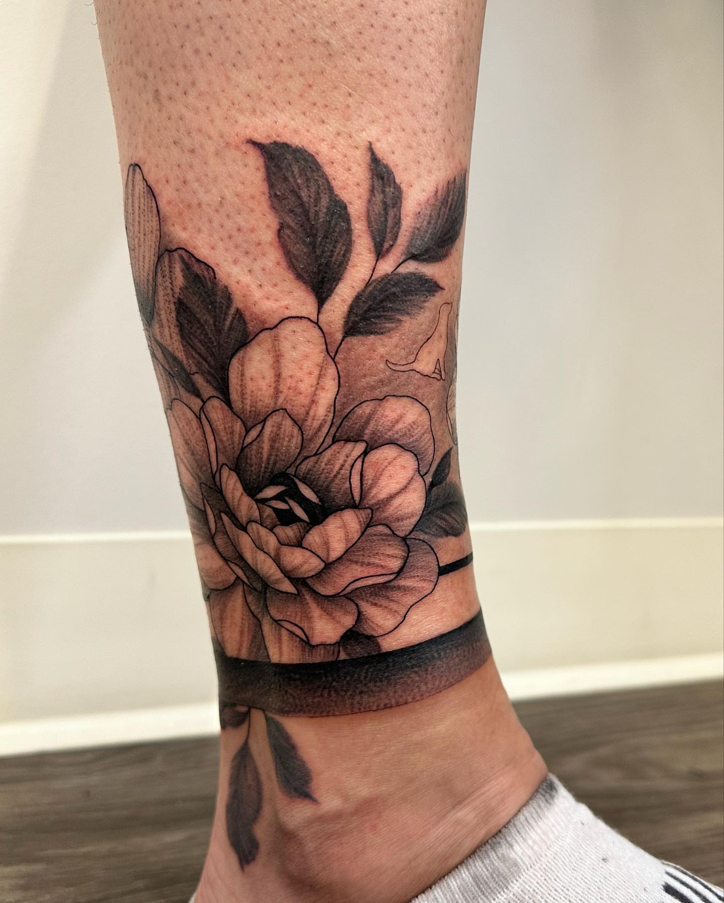 Flower black and grey tattoo on the forearm by Sam Oakes