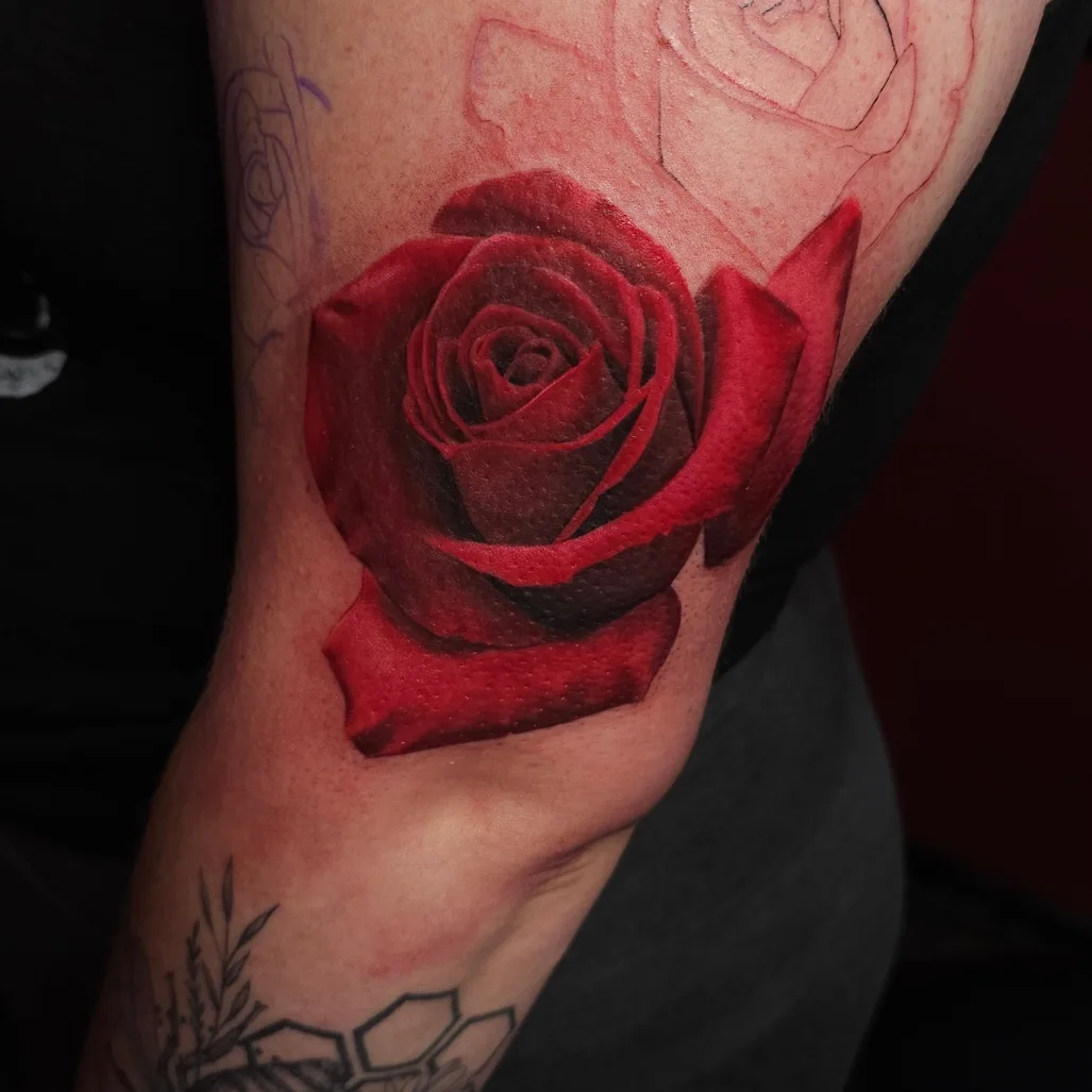 Red rose realism tattoo on the forearm by Gabrielle Nicole Soucie