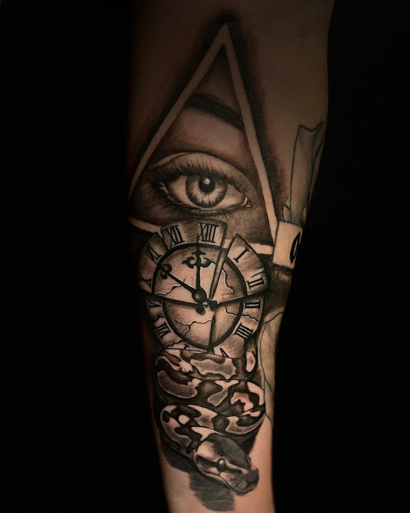 Eye and clock realism tattoo on the forearm by Miles Johnson