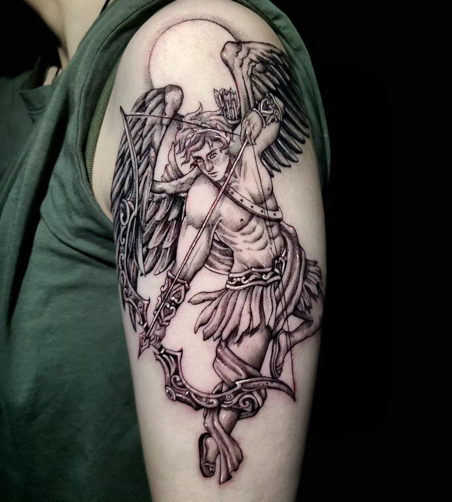 Angel with bow and arrow realism tattoo on the upper arm by Sydney Paige, Mentor, Ohio