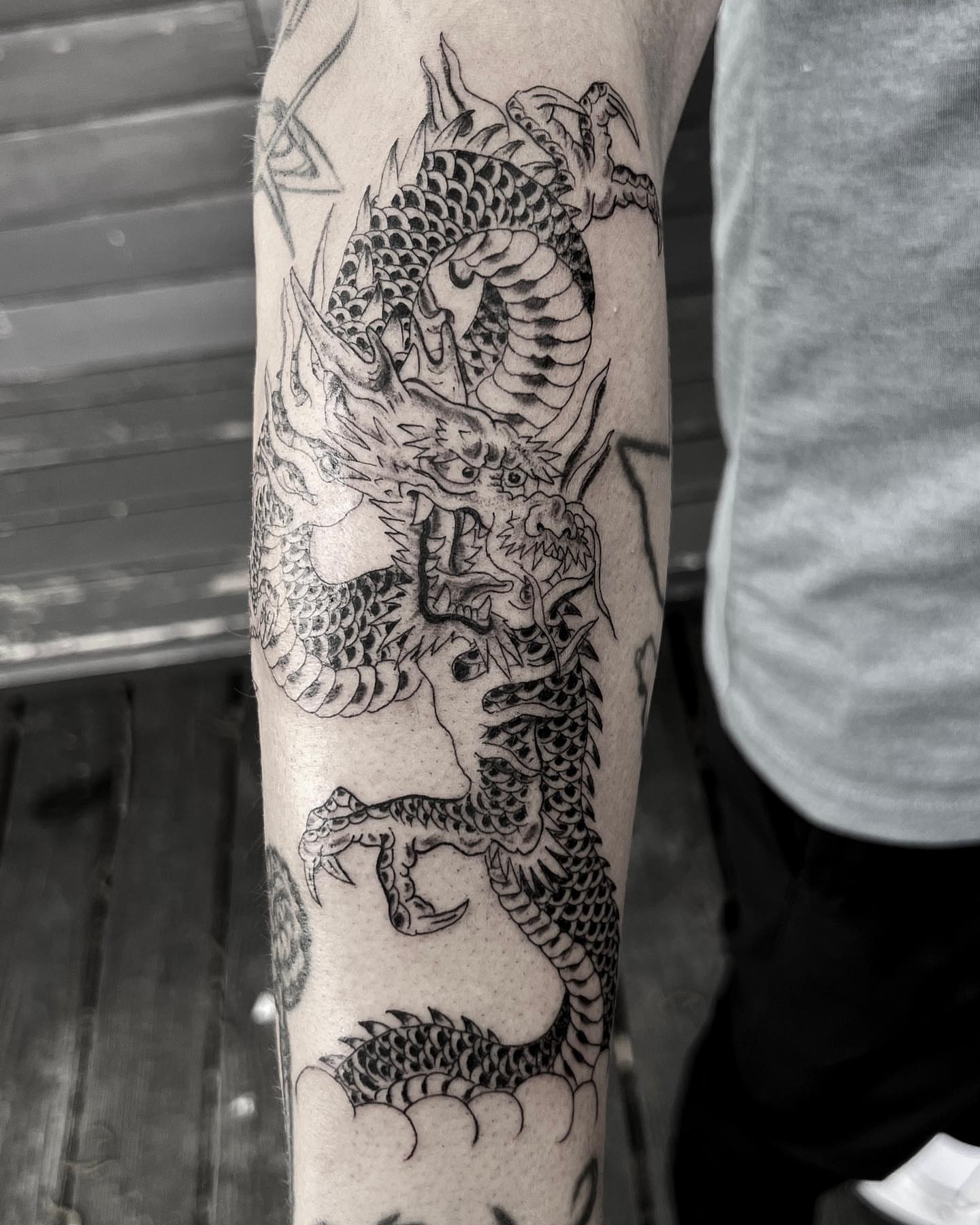 Dragon black and grey tattoo on the forearm by Jon Crook, Portland, Oregon