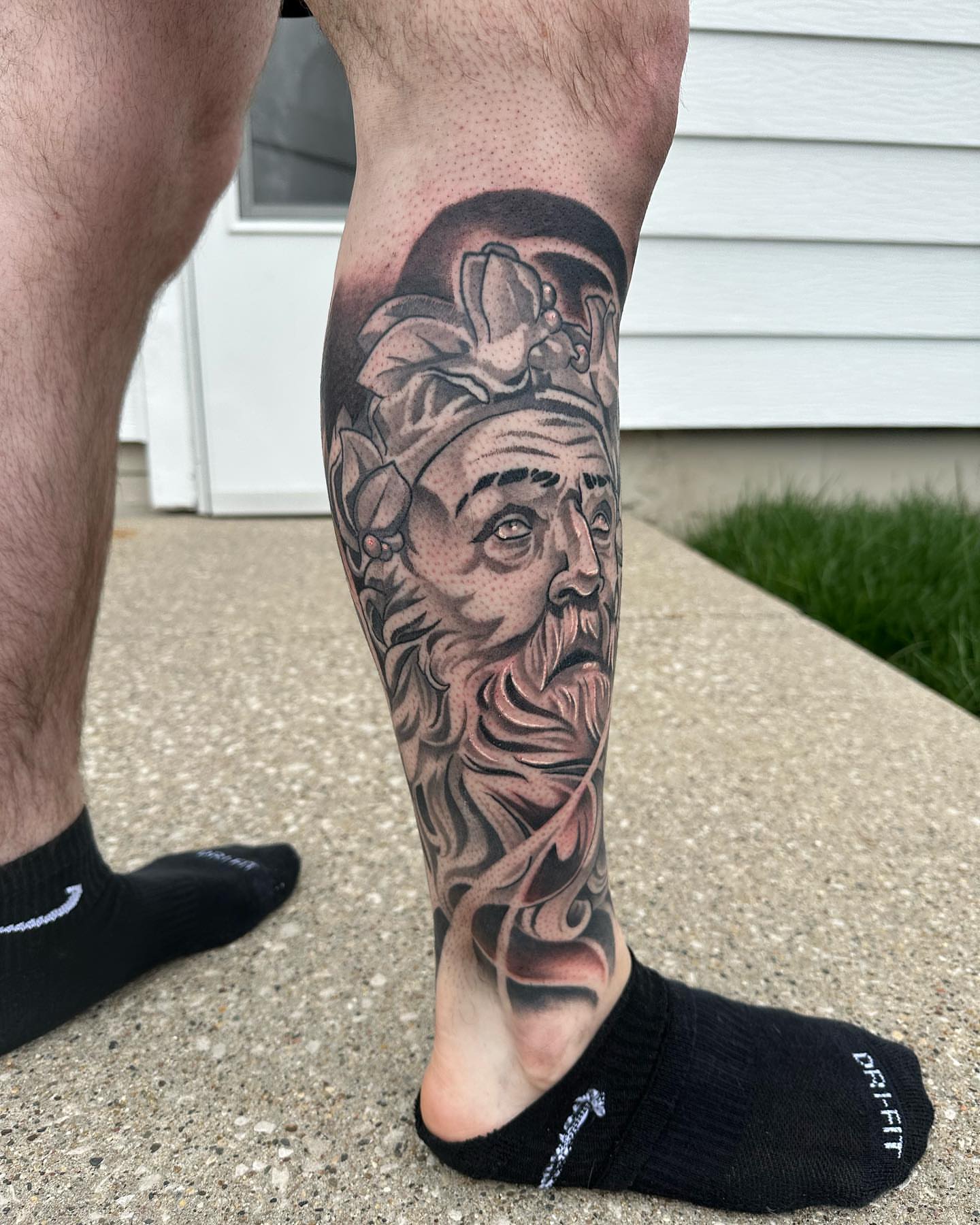 Bearded man's head realism tattoo on the calf by Derek Hutchison, Des Moines, Iowa