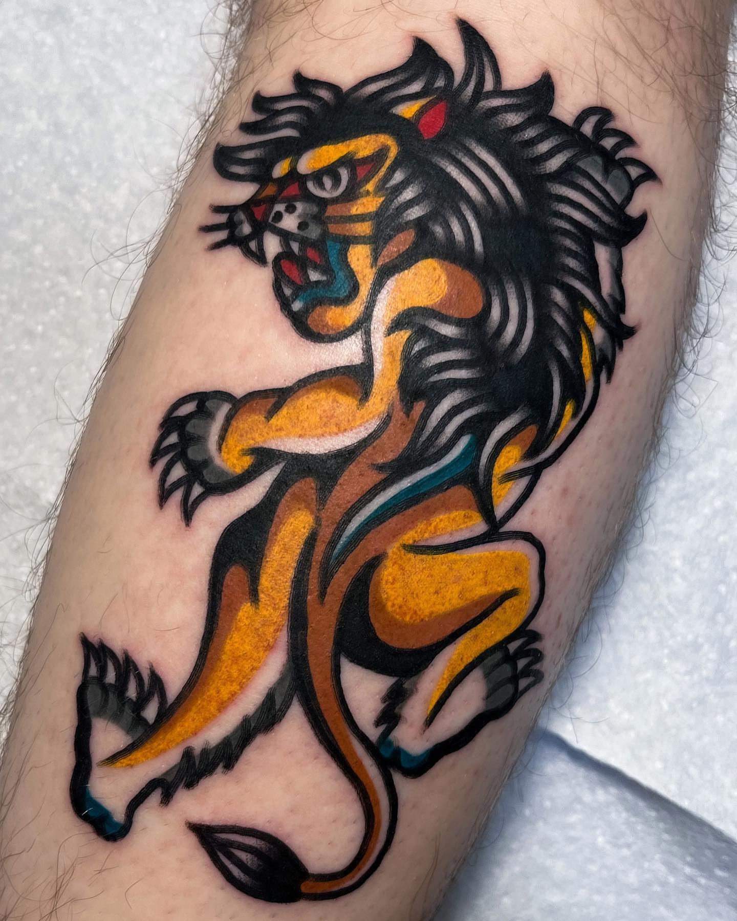 Lion American traditional tattoo on the forearm by Oldschool Tattooer Takii 타키
