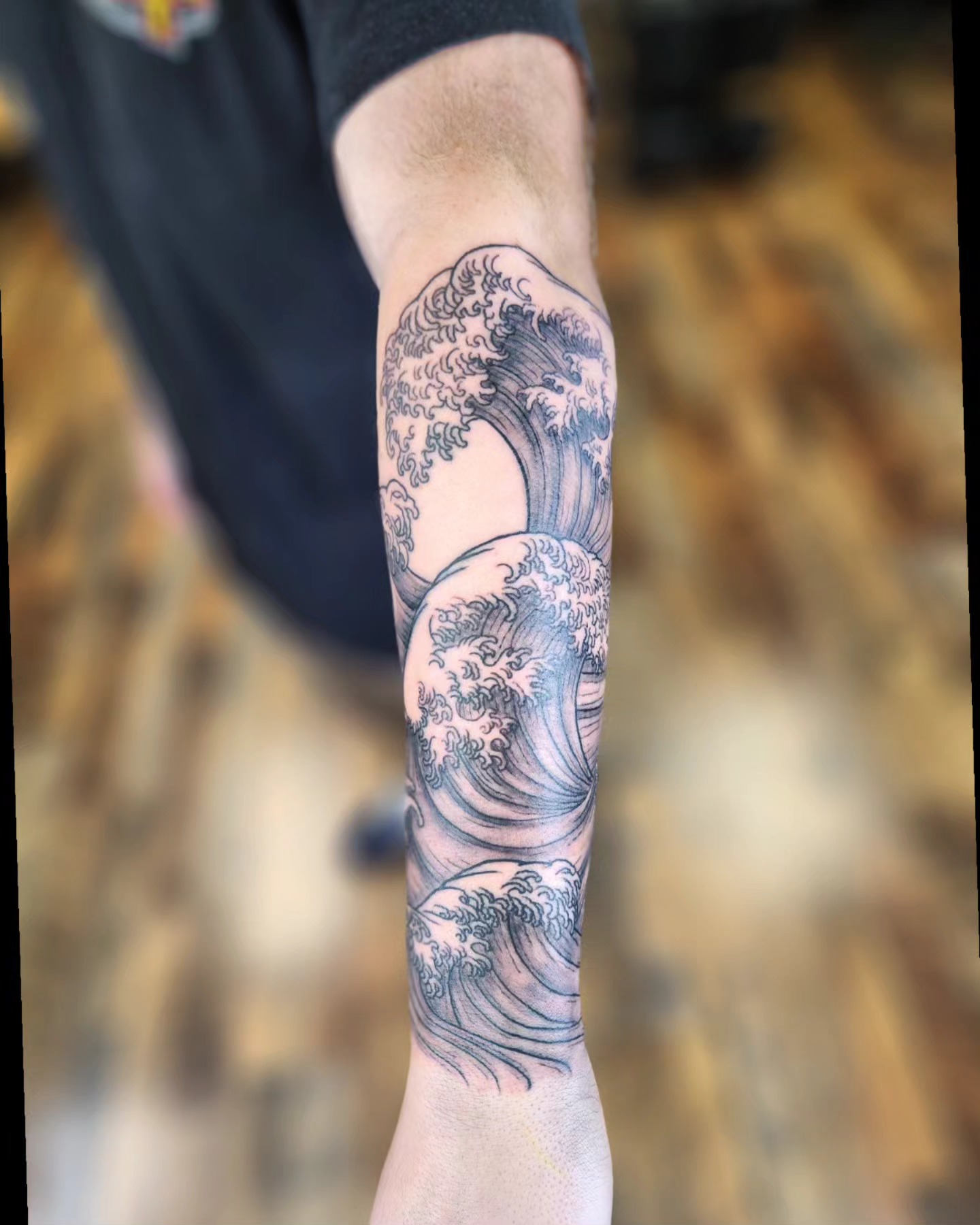 Waves black and grey tattoo on the forearm by Bry True