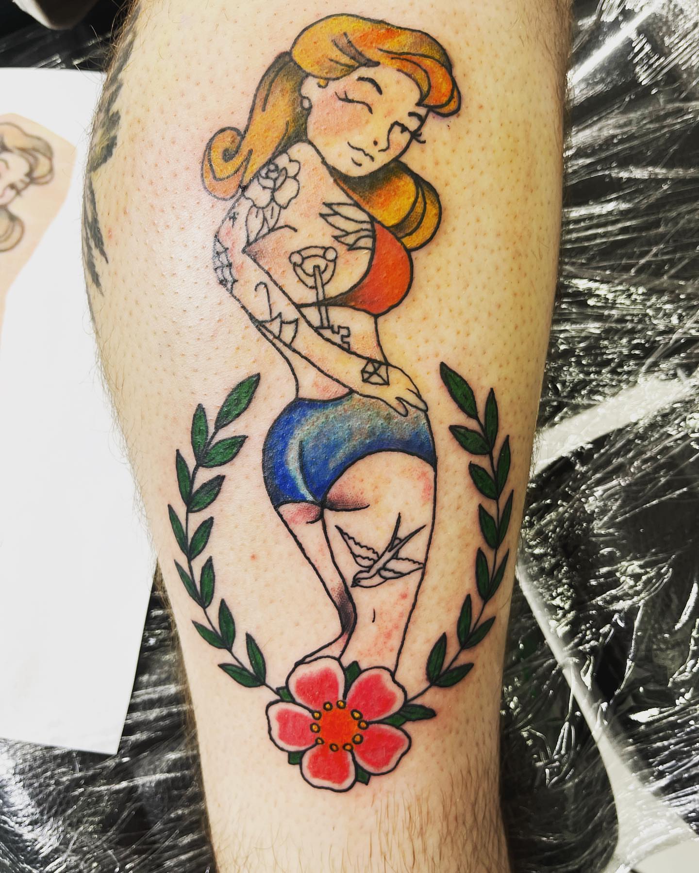 Pin-up girl American traditional tattoo on the thigh by Frankie Sodapop Plumley