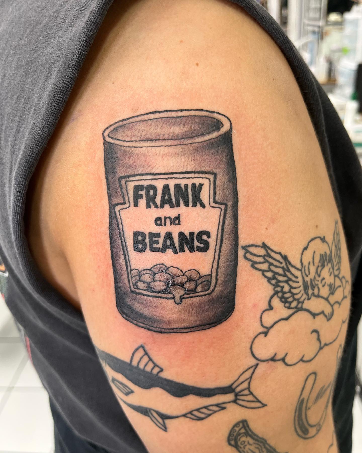 Frank and Beans can black and grey tattoo on the shoulder by Frankie Sodapop Plumley