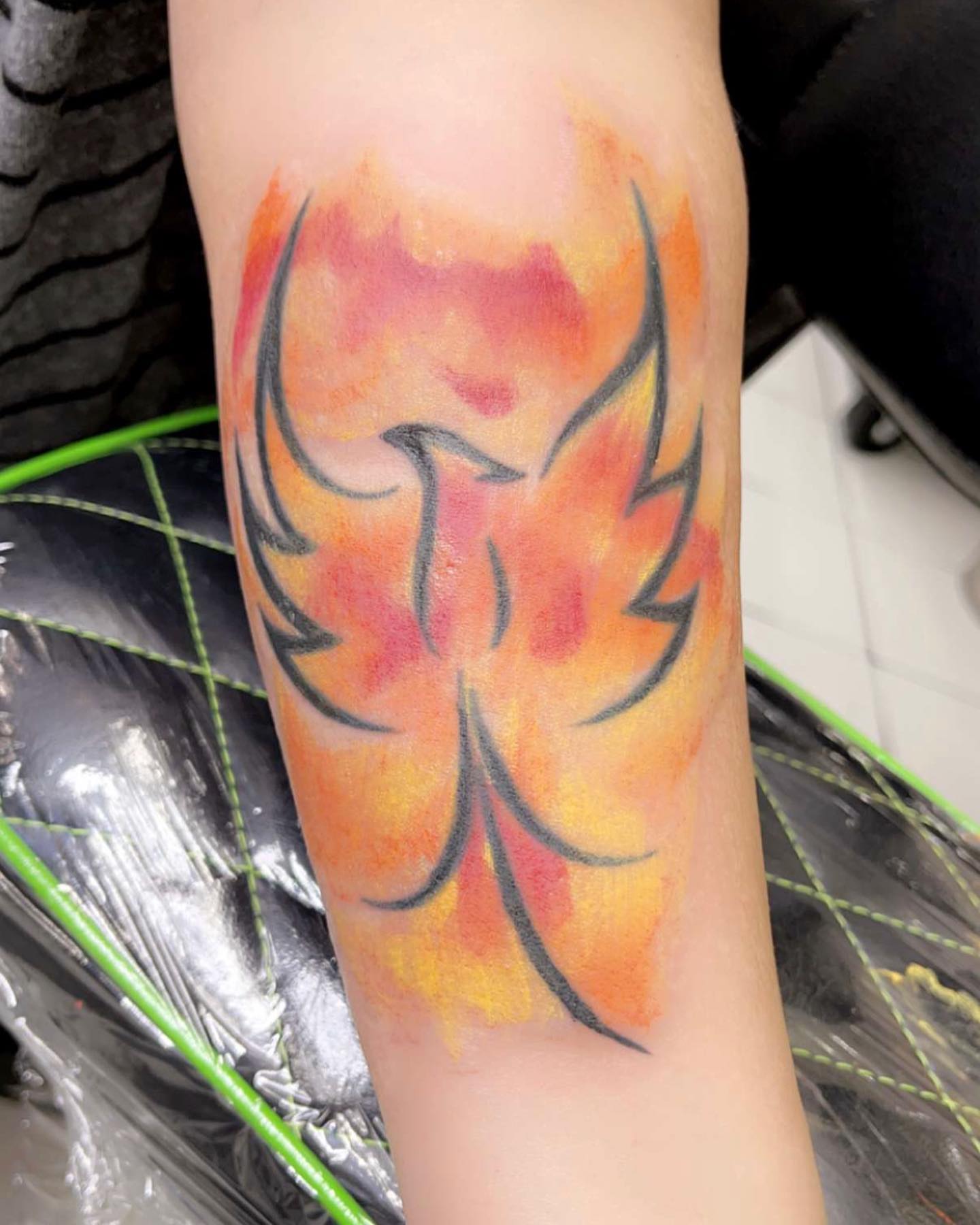 Flame watercolor tattoo on the forearm by Frankie Sodapop Plumley