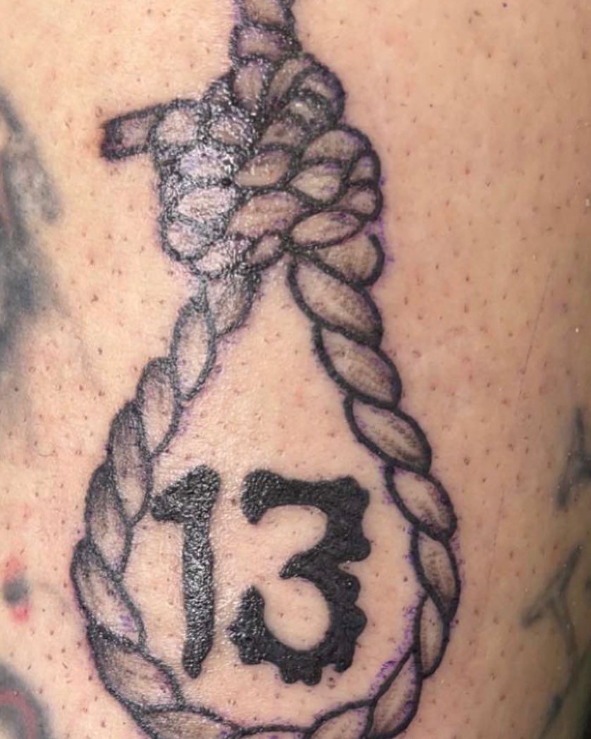 Number 13 black and grey tattoo on the upper arm by Frankie Sodapop Plumley