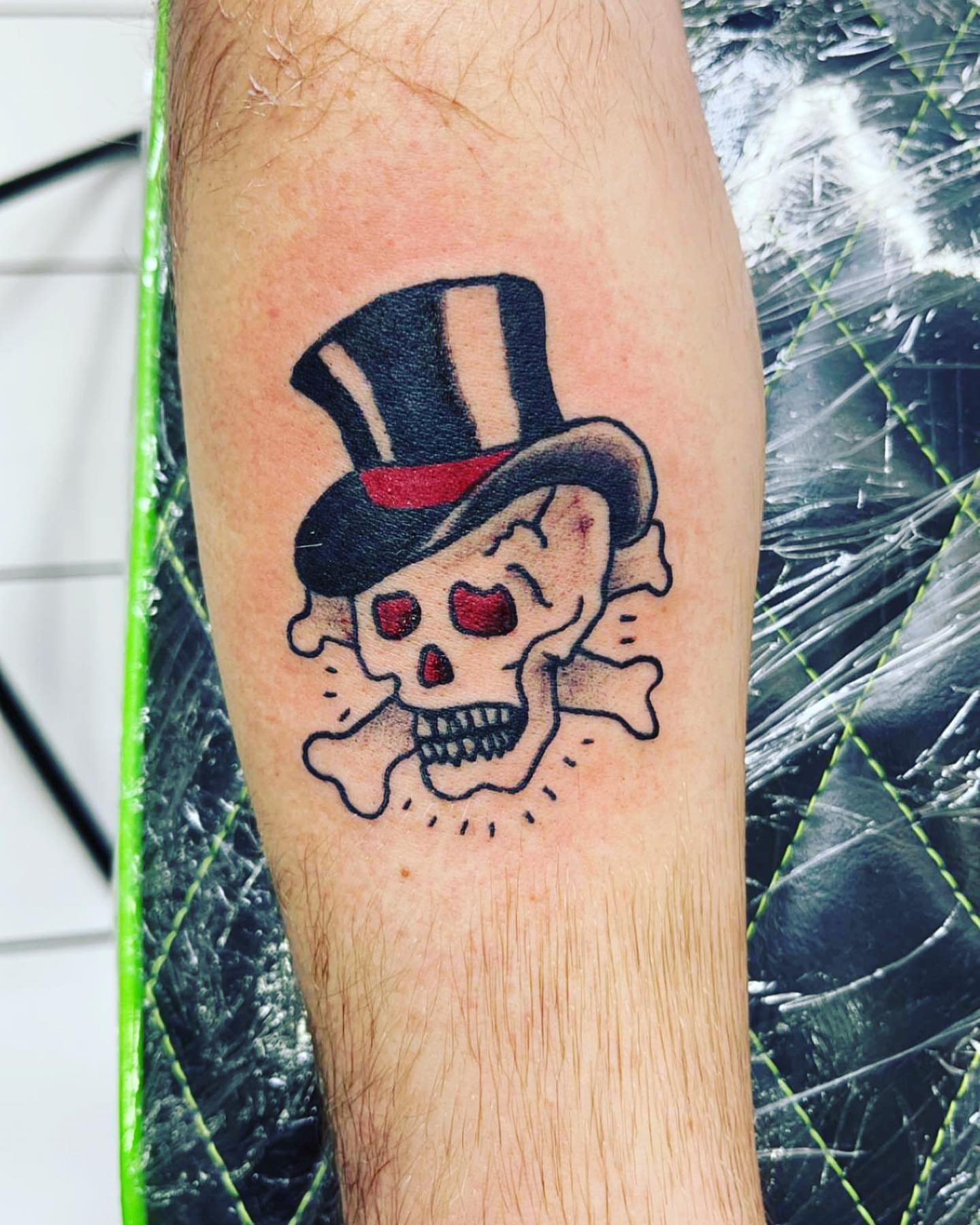 Skull wearing top hat American traditional tattoo on the forearm by Frankie Sodapop Plumley