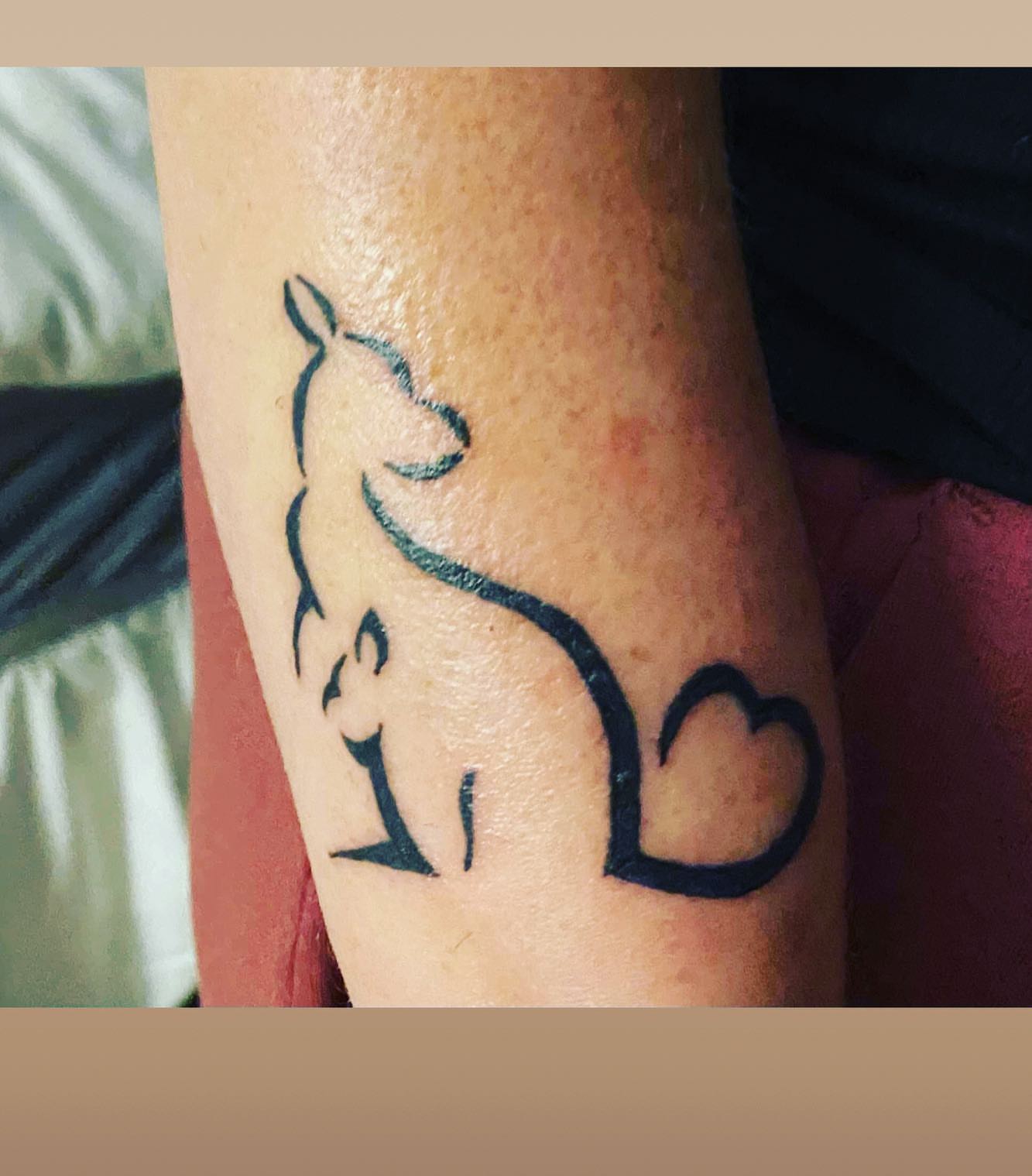 Cat silhouette minimalist tattoo on the forearm by Frankie Sodapop Plumley